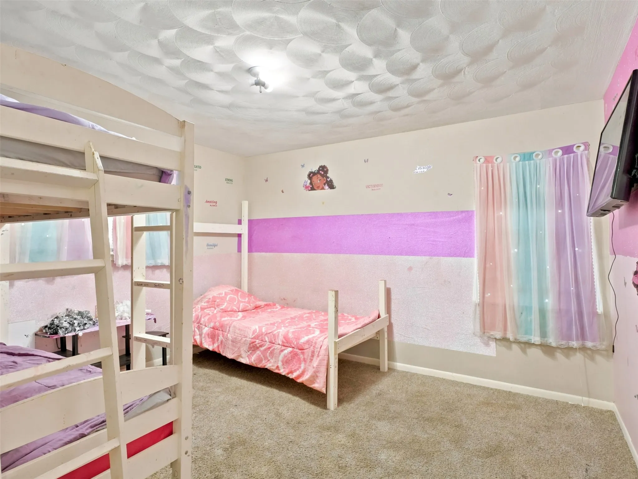 Plush carpeted flooring and textured ceiling treatment