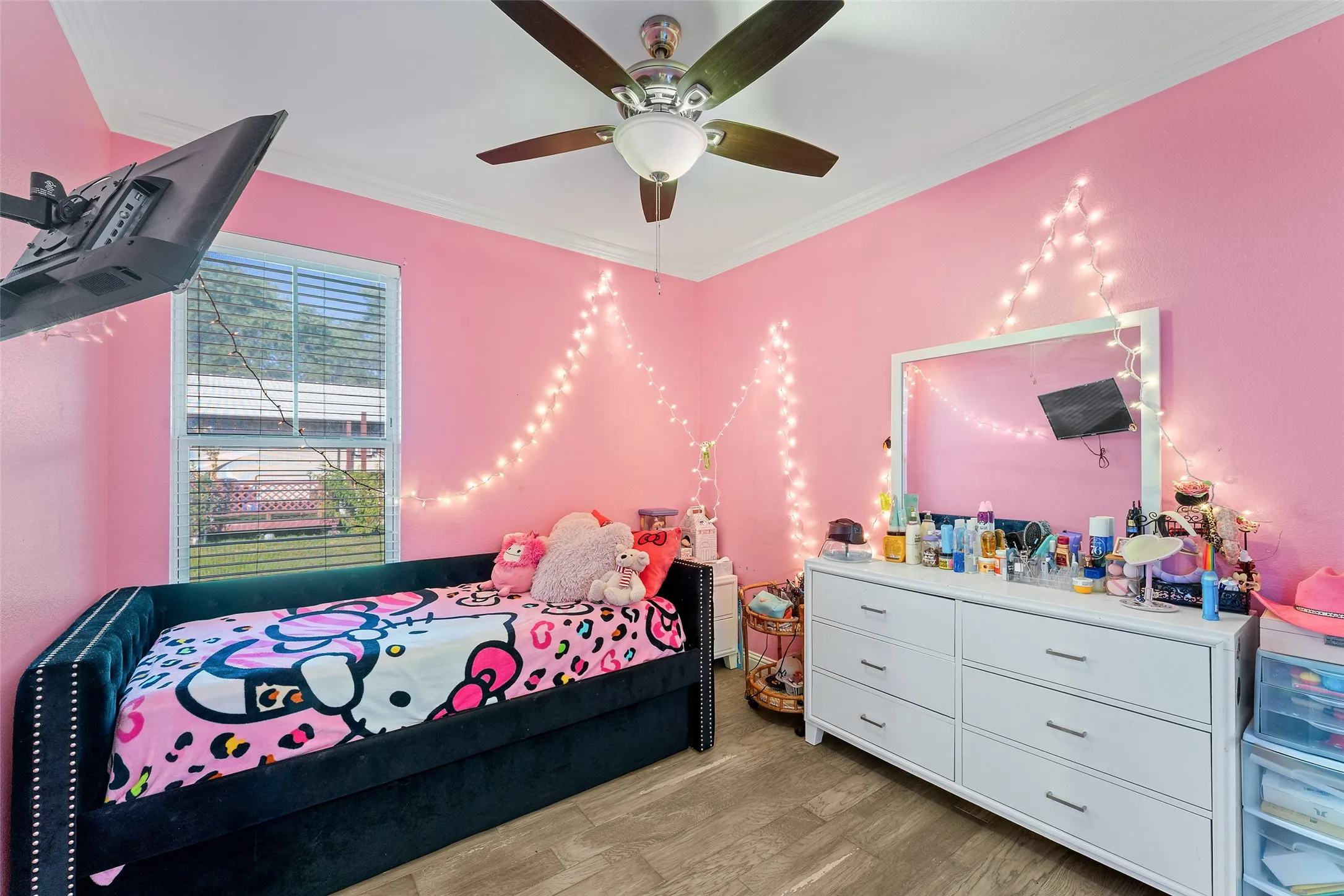 2nd Room featuring wood-finish flooring, a ceiling fan with light fixture, crown molding, and a window with blinds