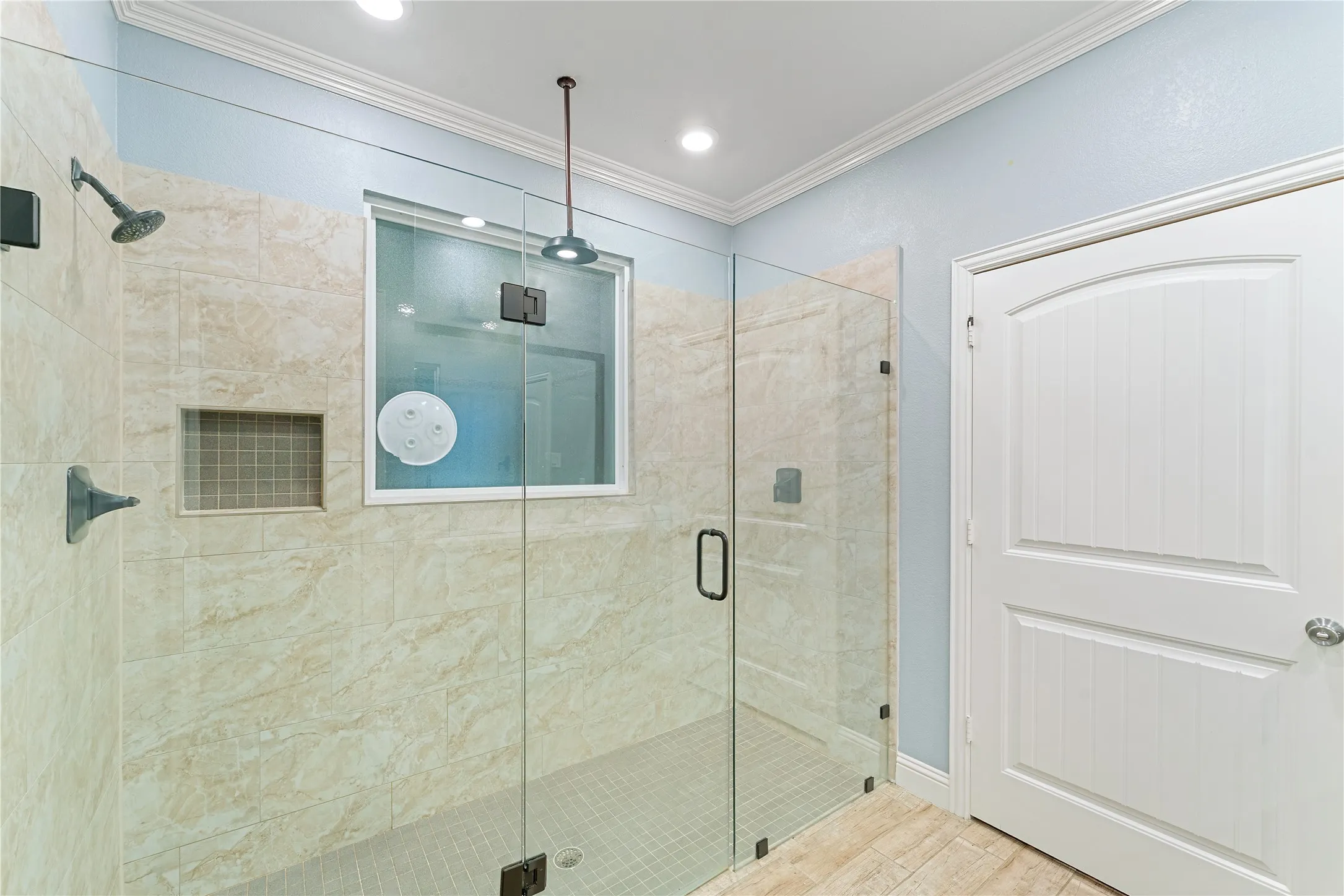 Masters Walk-in shower with clear glass enclosure and tile surround