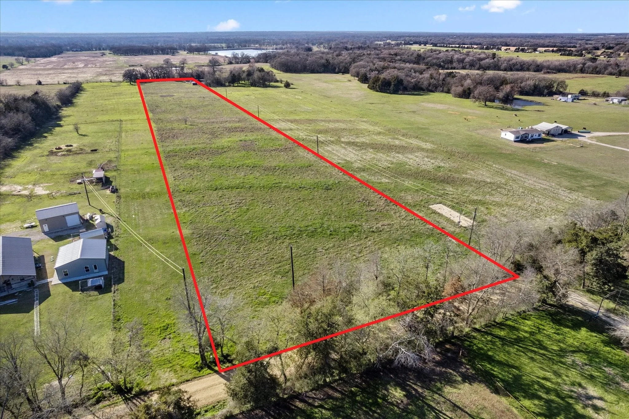 Expansive land parcel featuring clear boundaries and a mix of open pasture and mature trees
