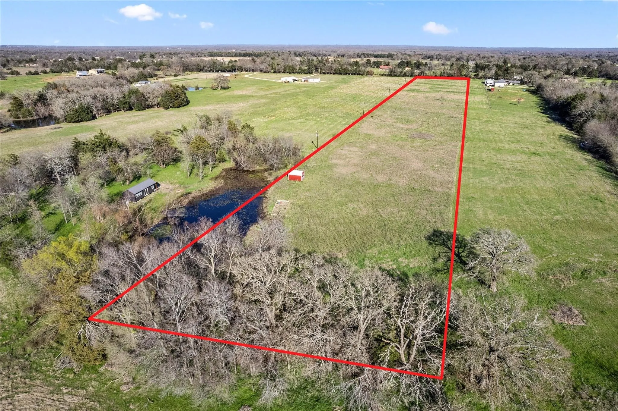 Expansive undeveloped land featuring a combination of open pasture and mature tree coverage
