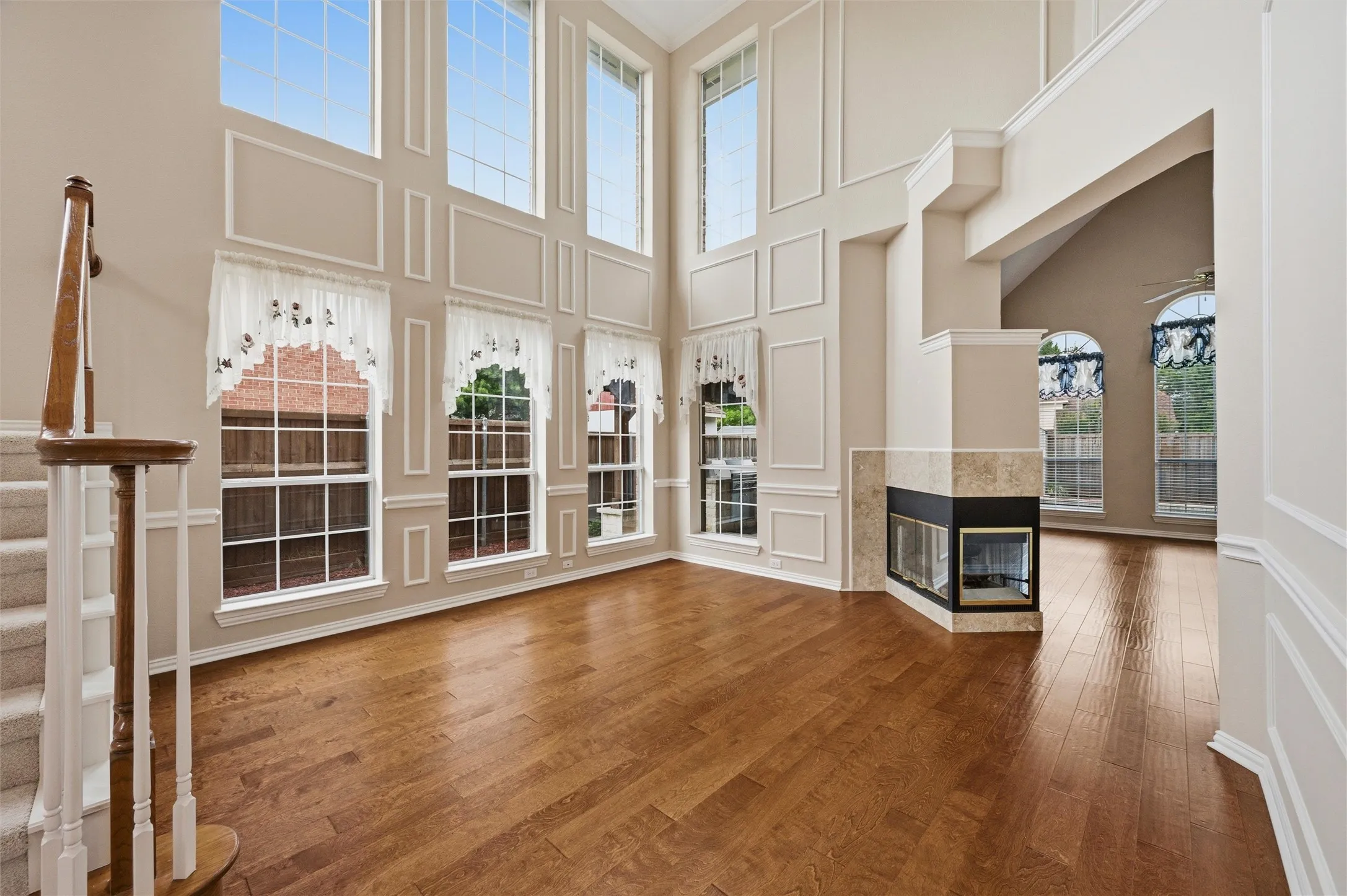 Another view of the office space with shared gas fireplace - 2 story ceilings