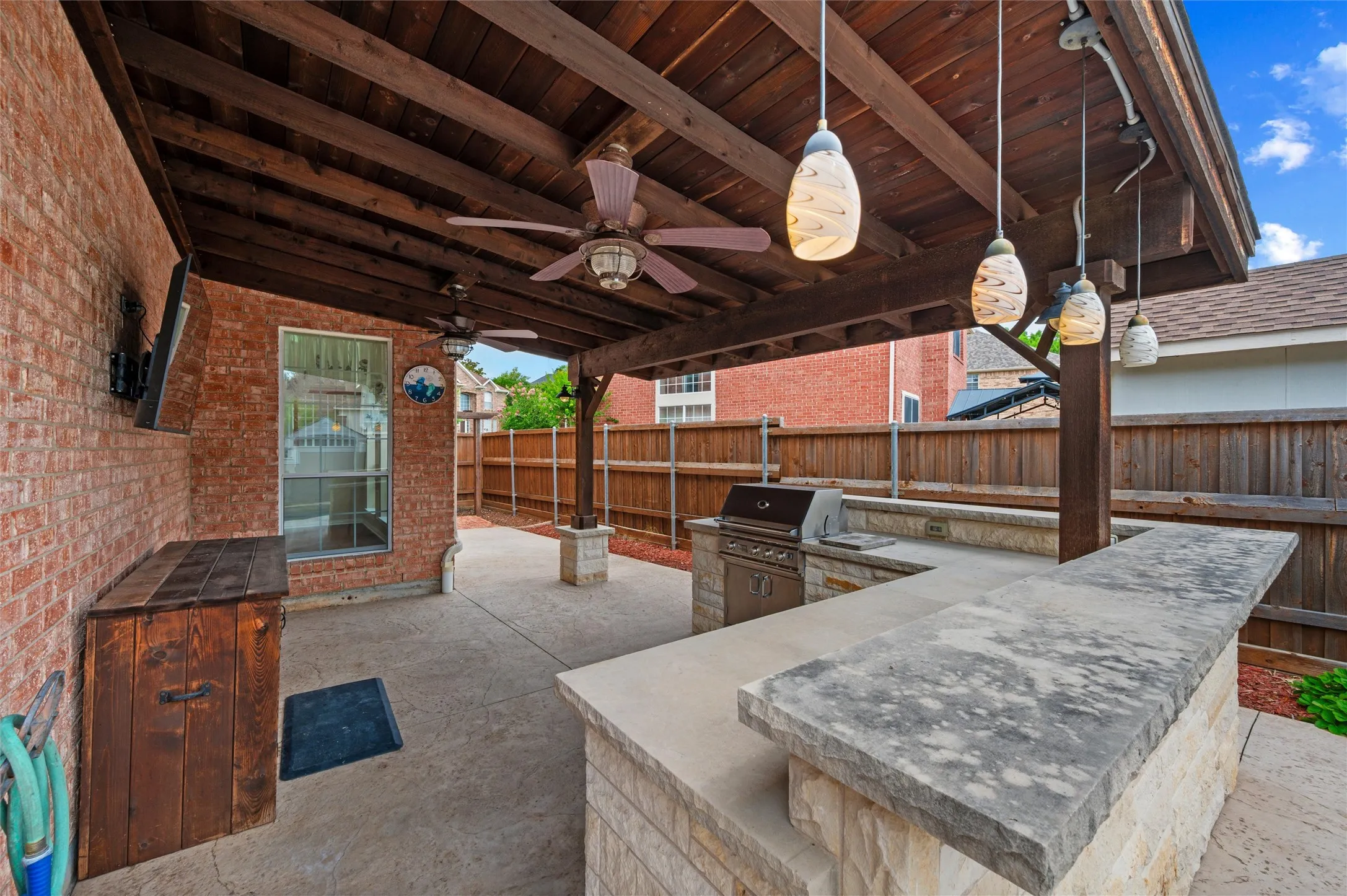 Back Patio   PENDNT LIGHTING = BOARD ON BOARD PRIVACY FENCING  - ADDITIONAL STORAGE UNDER MOUNTED TV