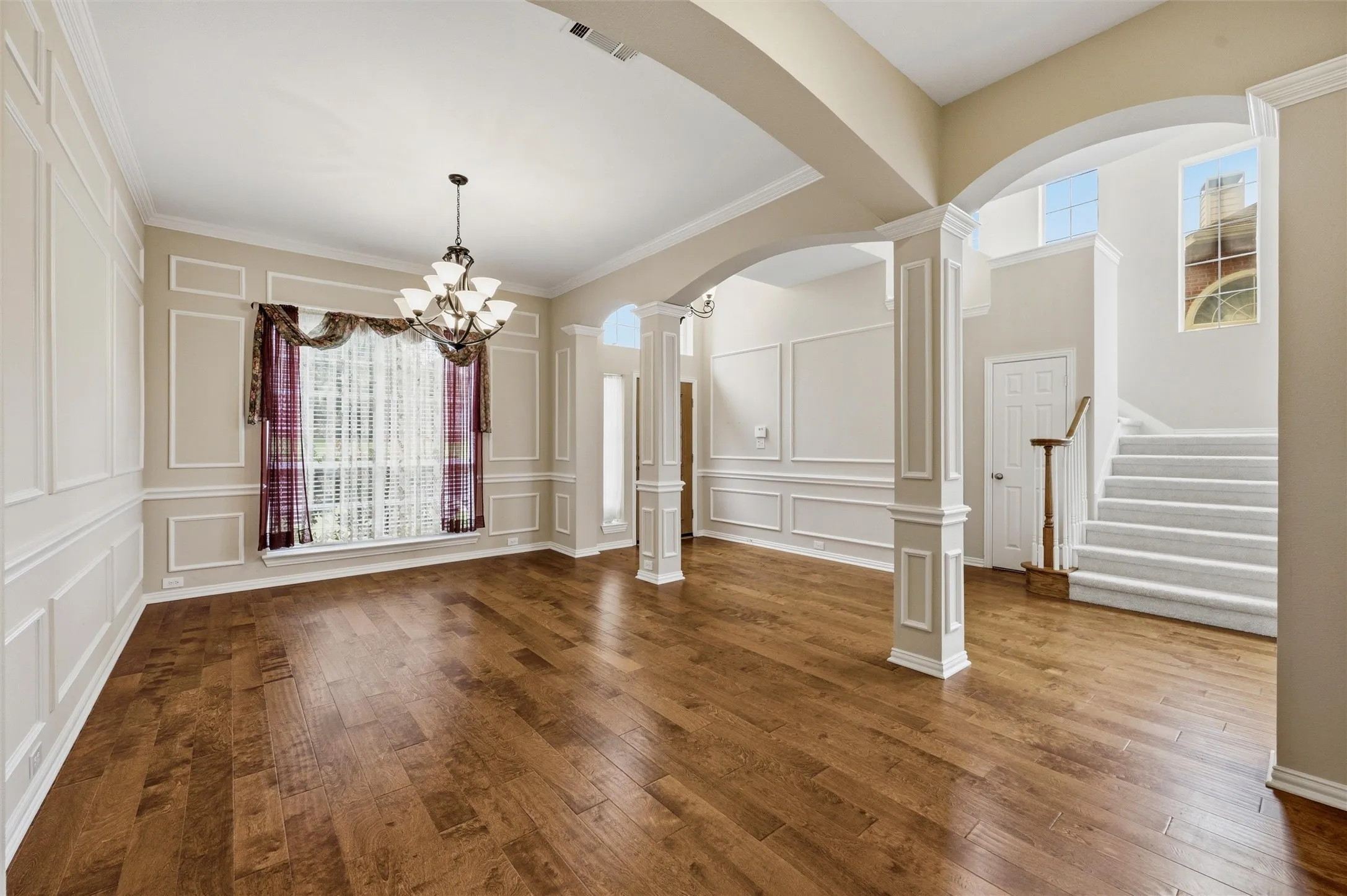 Beautirul columns enhance the dining room and the entry - view of coat closet next to steps - 1/2 bath also in that area -