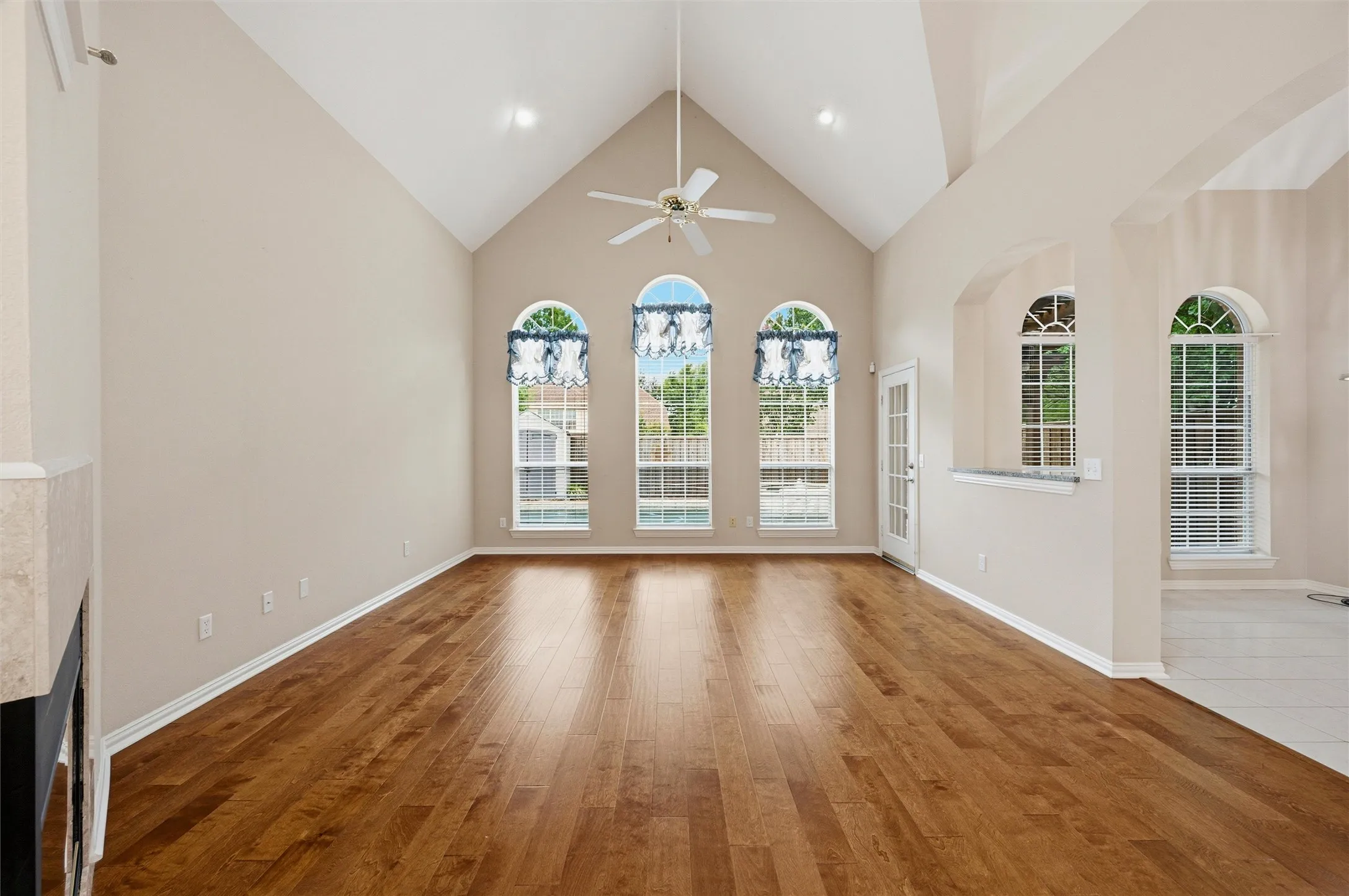 Formal Living Room with vaulted ceilings viewing the Pool and open to the kitchen