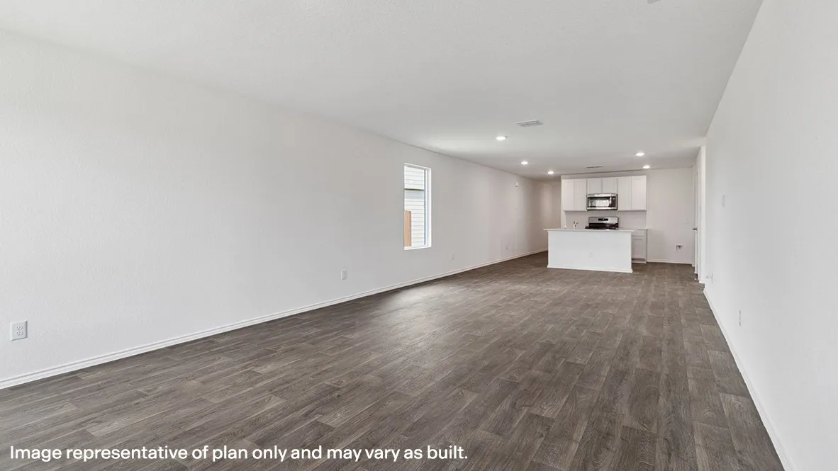 Open-concept living space featuring wood-finish flooring, recessed lighting, and a kitchen island with a white countertop