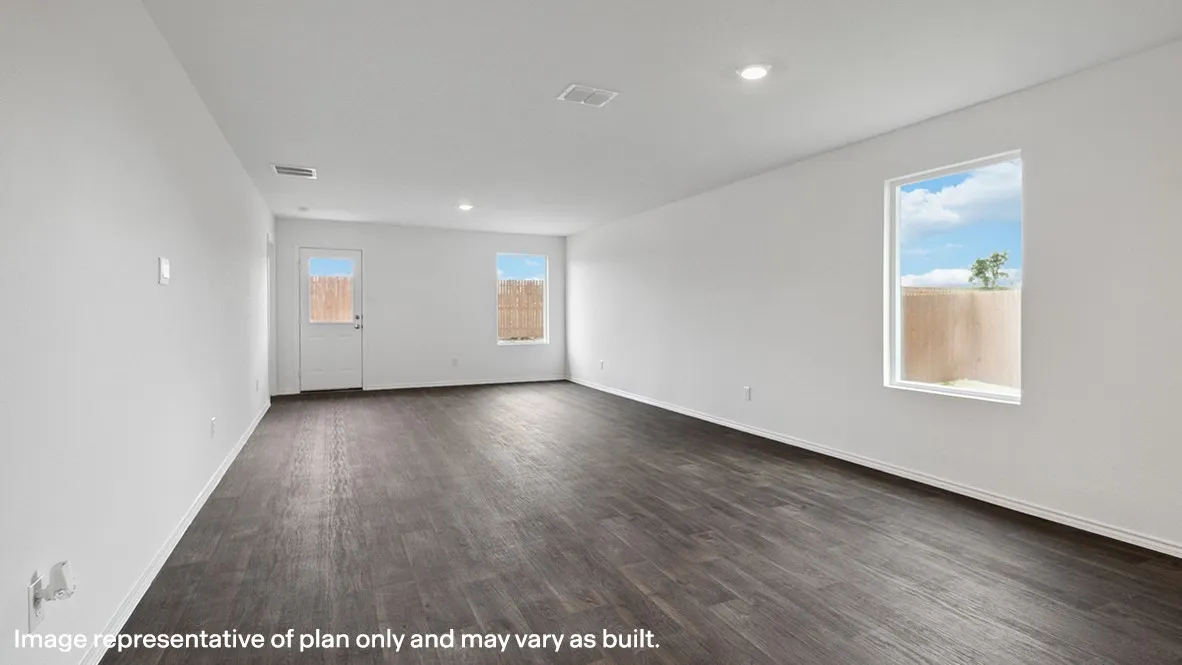 Spacious interior room featuring dark wood-finish flooring, white walls, and recessed lighting