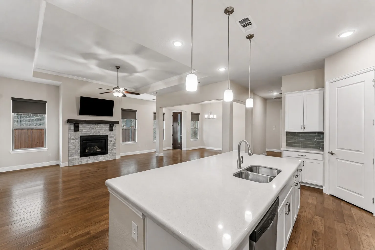 Large quartz island anchors the kitchen and overlooks the spacious family room for effortless entertaining.
