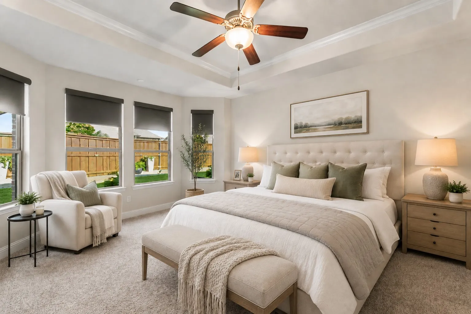 Spacious primary suite with tray ceiling, abundant natural light, and room for a sitting area. Enjoy this virtually staged room for furniture placement ideas.