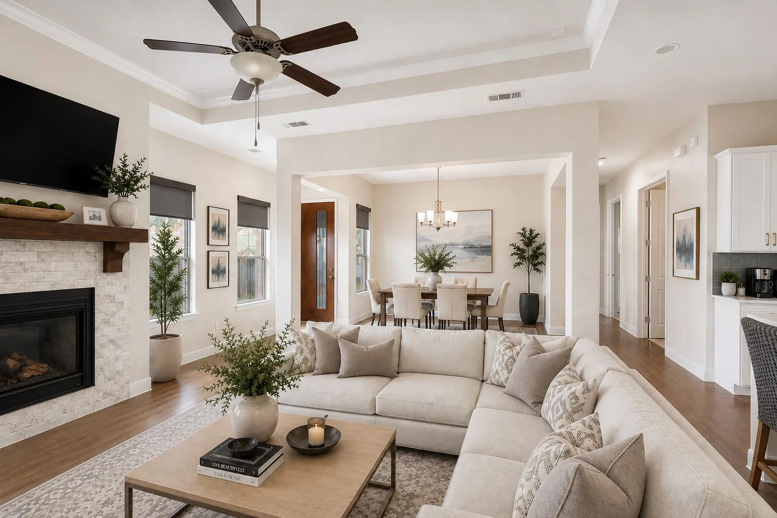 Expansive open-concept living seamlessly connects the family room, kitchen, and dining areas—perfect for everyday living and entertaining! Enjoy this virtually staged room for furniture placement ideas.