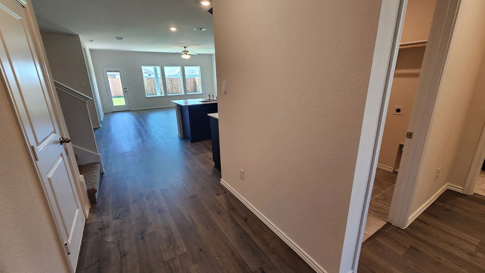 Open-concept living area featuring wood-finish flooring, a contemporary ceiling fan, and recessed lighting