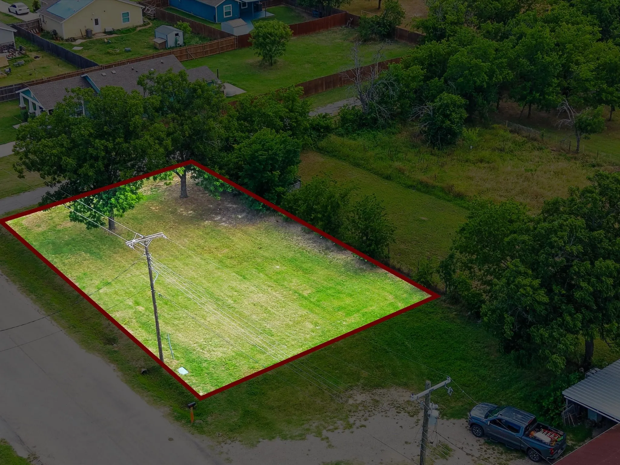 Clear, level lot featuring established trees and green space