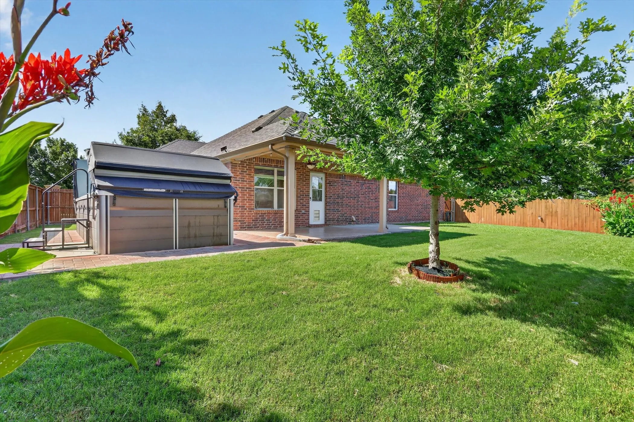 large backyard with epoxy front porch and lap pool and spa to enjoy year around
