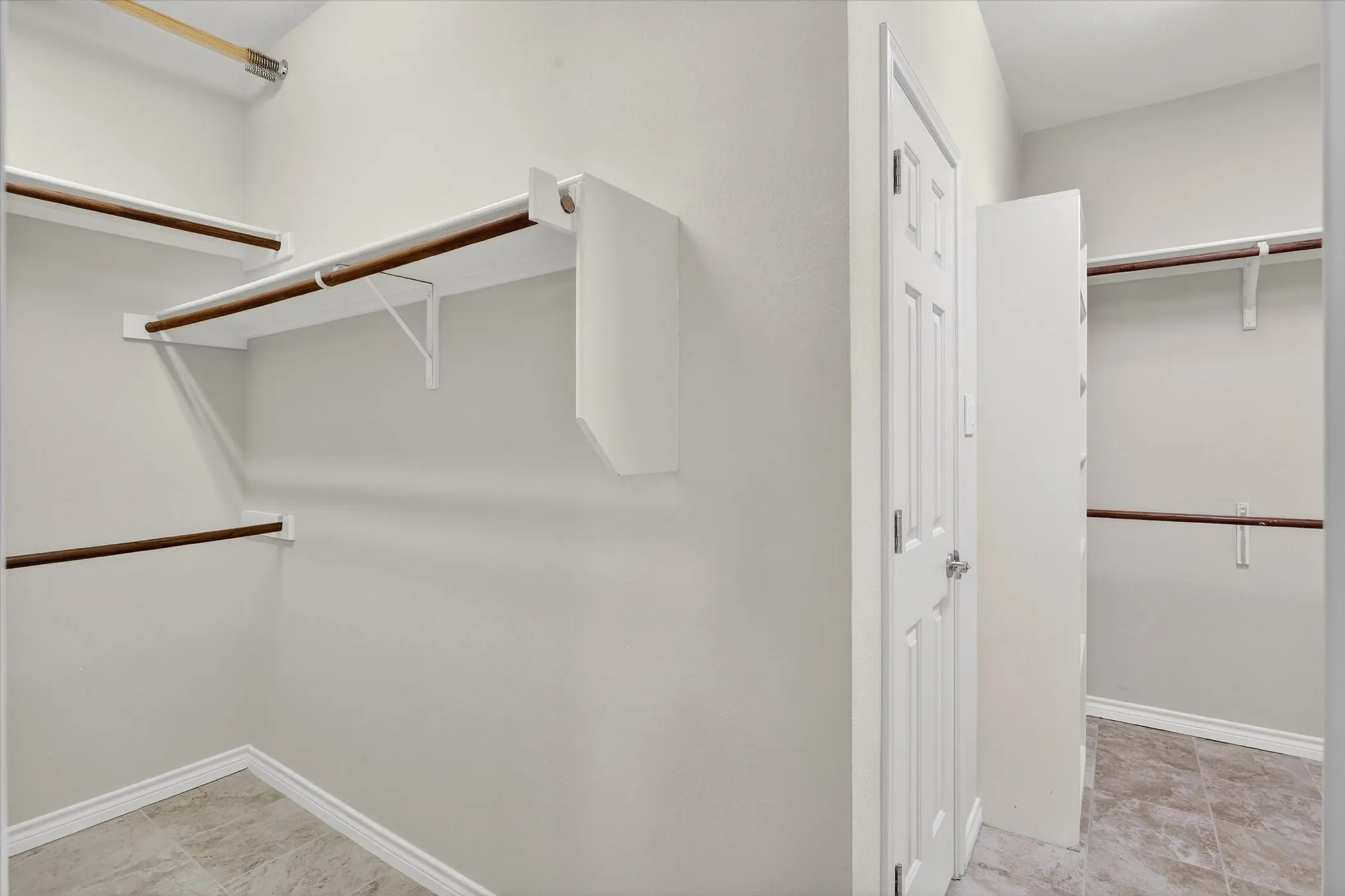 Primary suite Large his her closet with laundry room connection