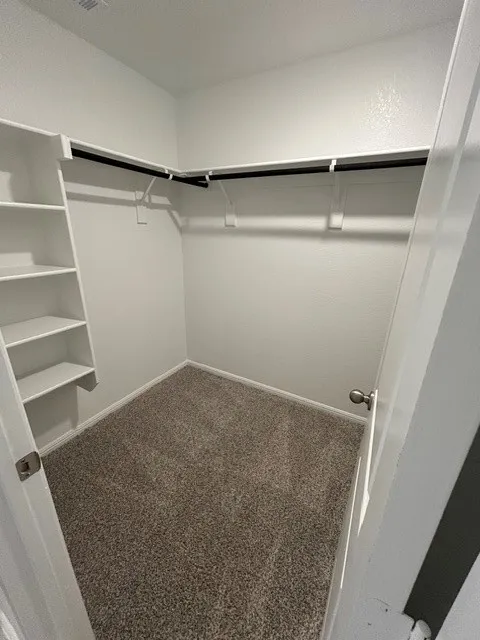 Primary bedroom walk-in closet.