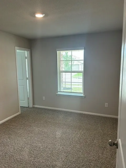 Bedroom #3 with ceiling fan and walk-in closet.
