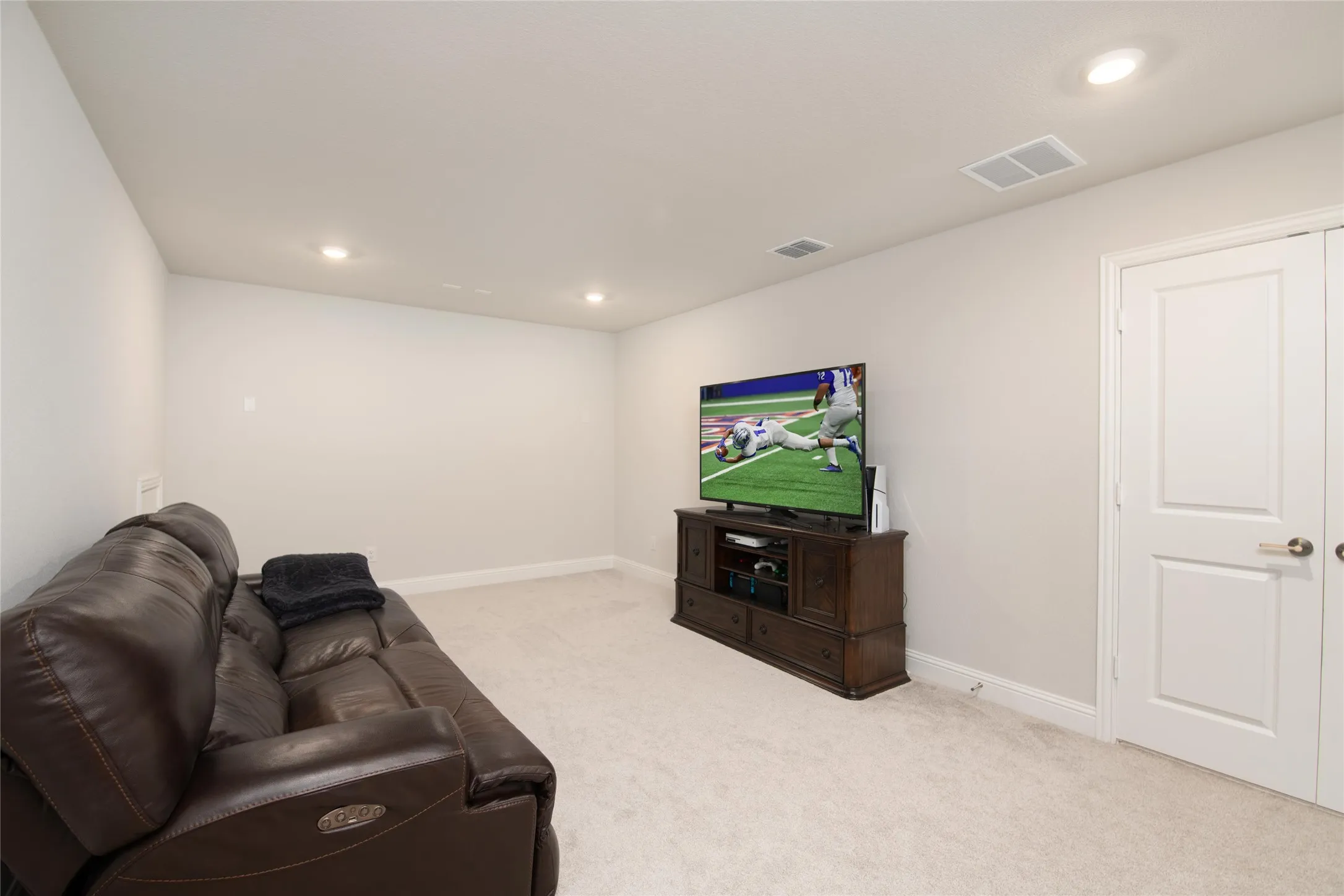 Selected as a builder upgrade, this private media room is tucked behind French doors just off the game room, creating the perfect space to enjoy movies and entertainment without disturbing the rest of the home.