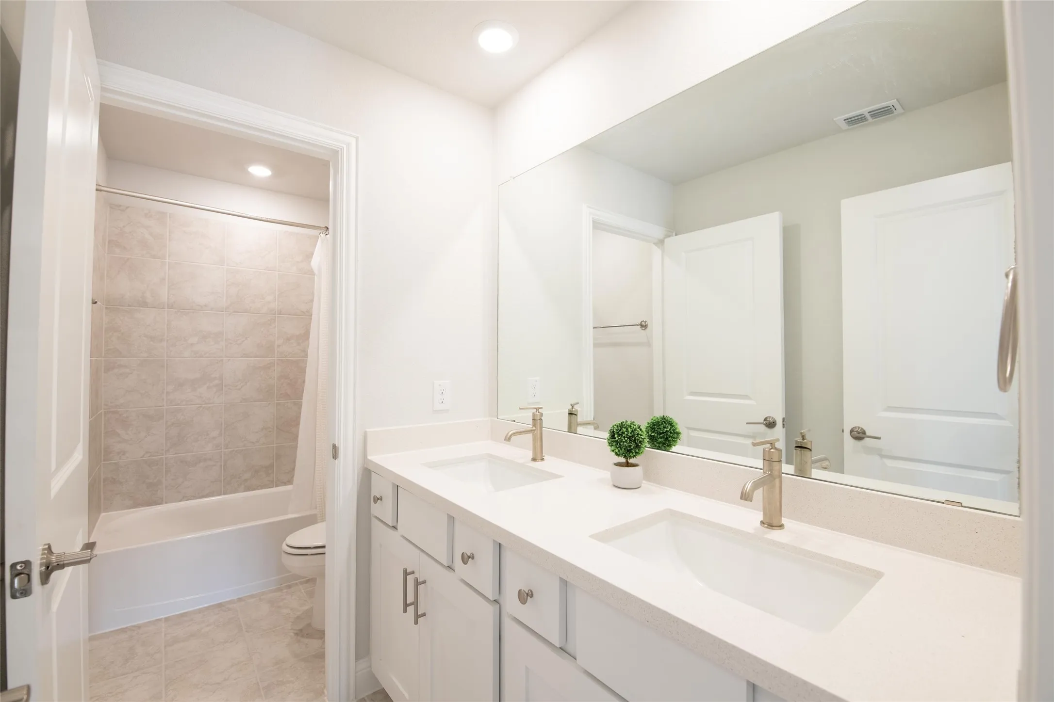 Designed for busy households, the upstairs full bath features dual sinks, abundant counter space, and a separate tub and shower area, making morning routines more efficient.