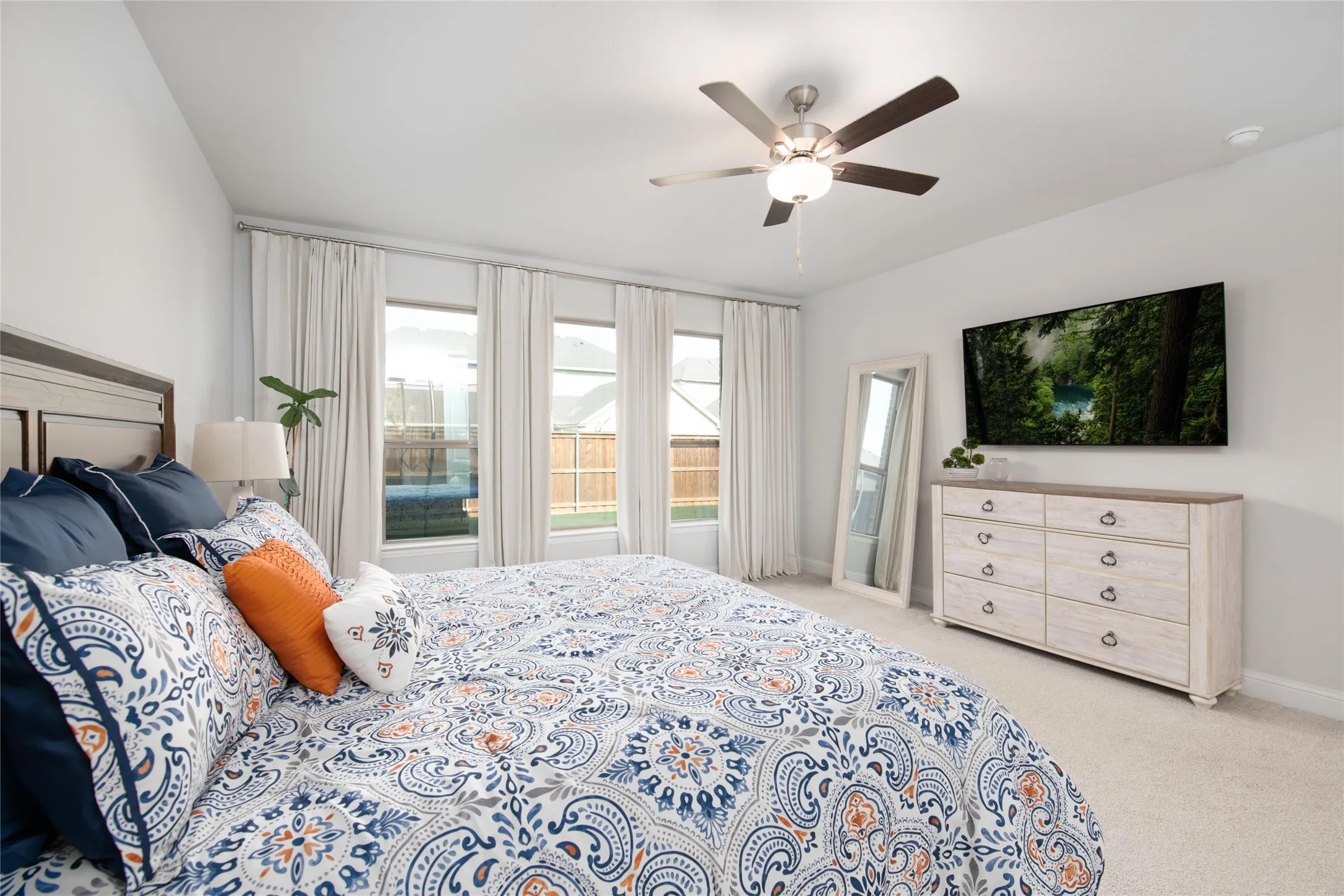 A wall of windows fills the room with natural light, while the expanded layout provides ample space for a sitting area, reading nook, exercise equipment, or private retreat.