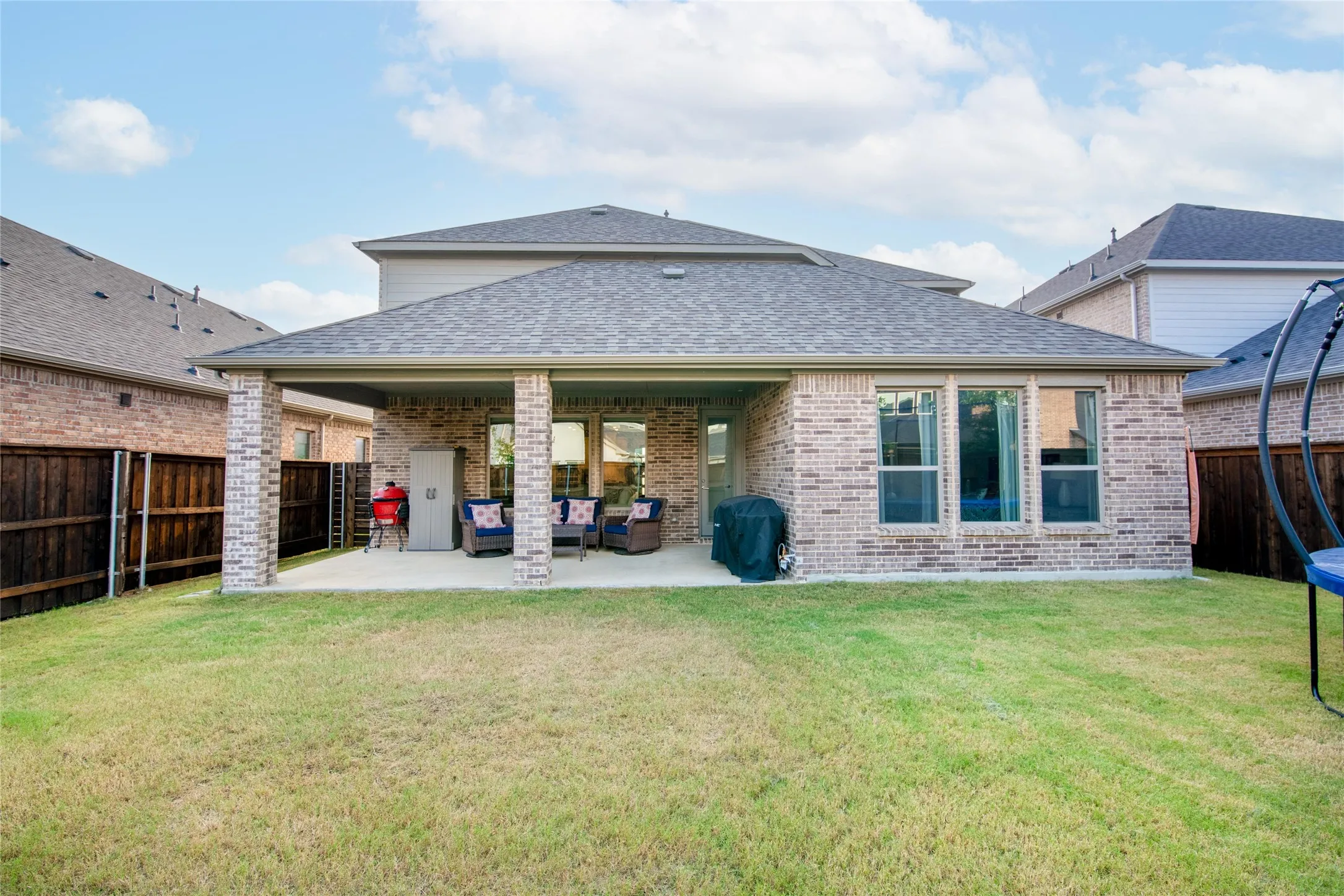 Step outside to a generously sized backyard with a wood privacy fence and plenty of room for pets, play, gardening, or future outdoor enhancements. The extended covered patio creates a seamless connection between indoor comfort and outdoor enjoyment.