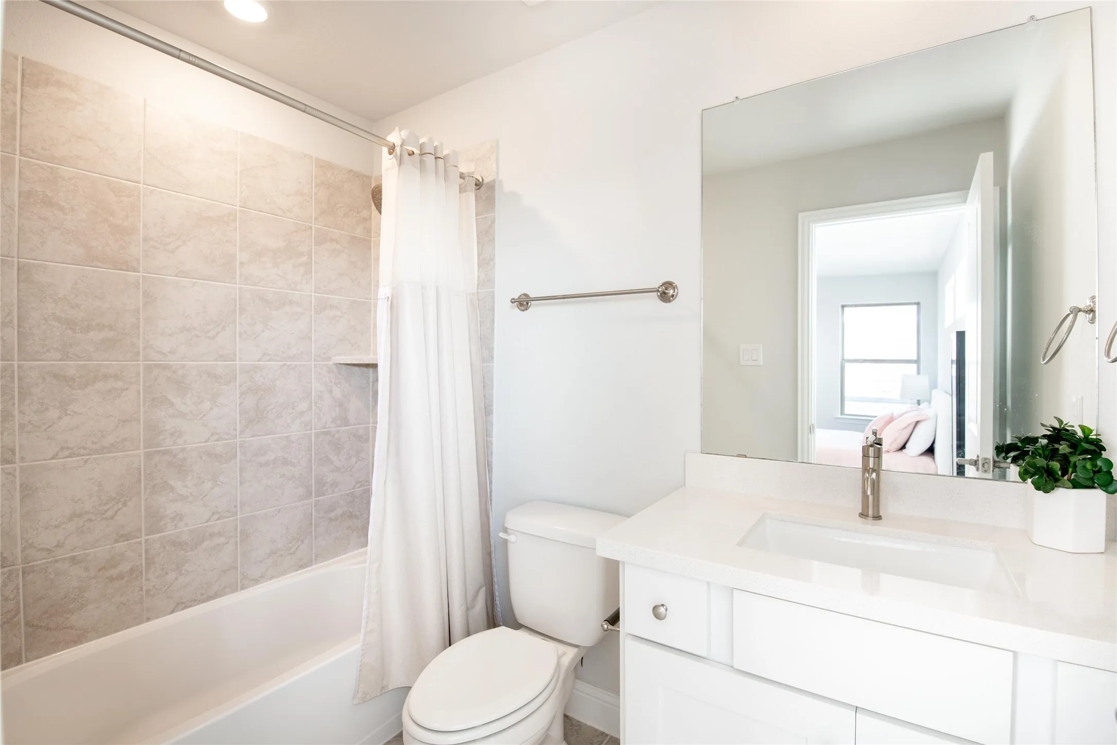 Complete with a private full bath featuring quartz countertops, modern finishes, and a tub/shower combination, this ensuite creates a comfortable and self-contained retreat for guests or family members.