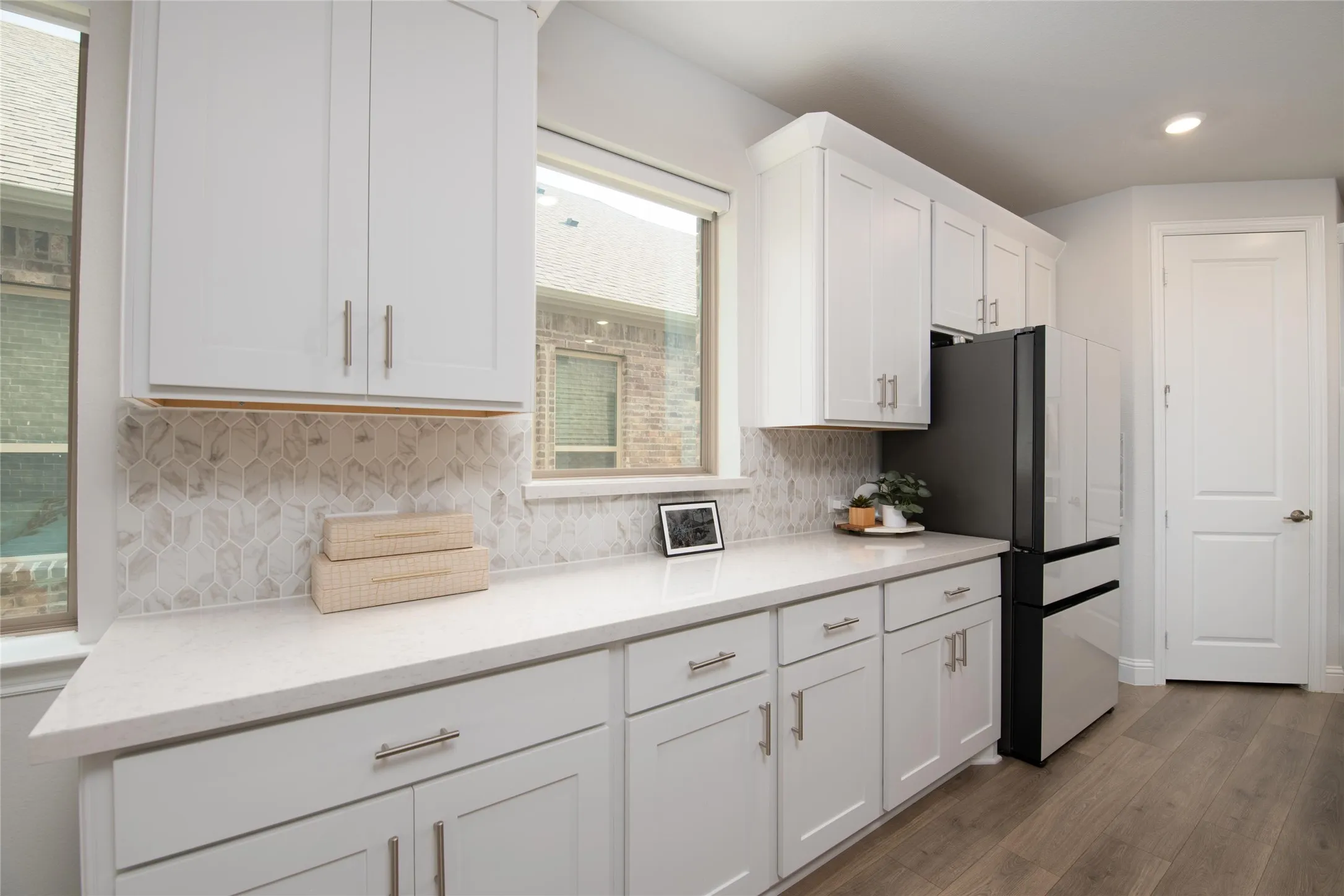 A farmhouse sink, generous counter space, and plentiful storage make this kitchen as practical as it is beautiful.