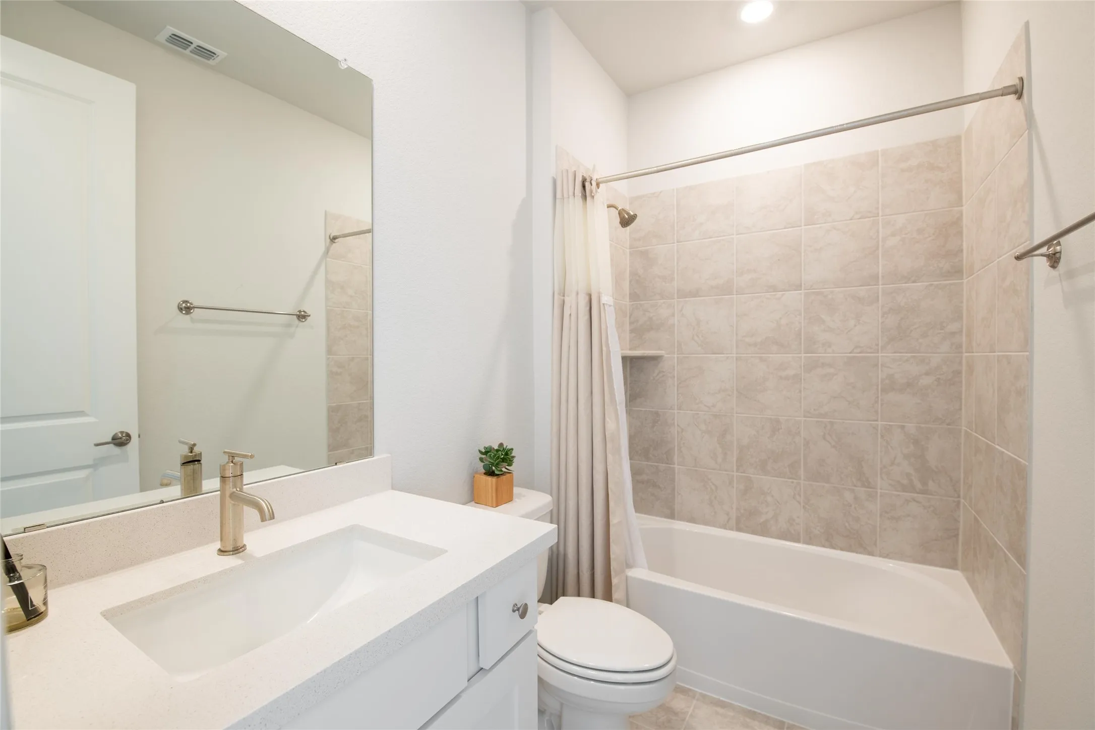 Designed for comfort and independence, the private ensuite bath features quartz countertops, modern finishes, and convenient access from the multi-generational suite, creating a true retreat for guests or extended family.