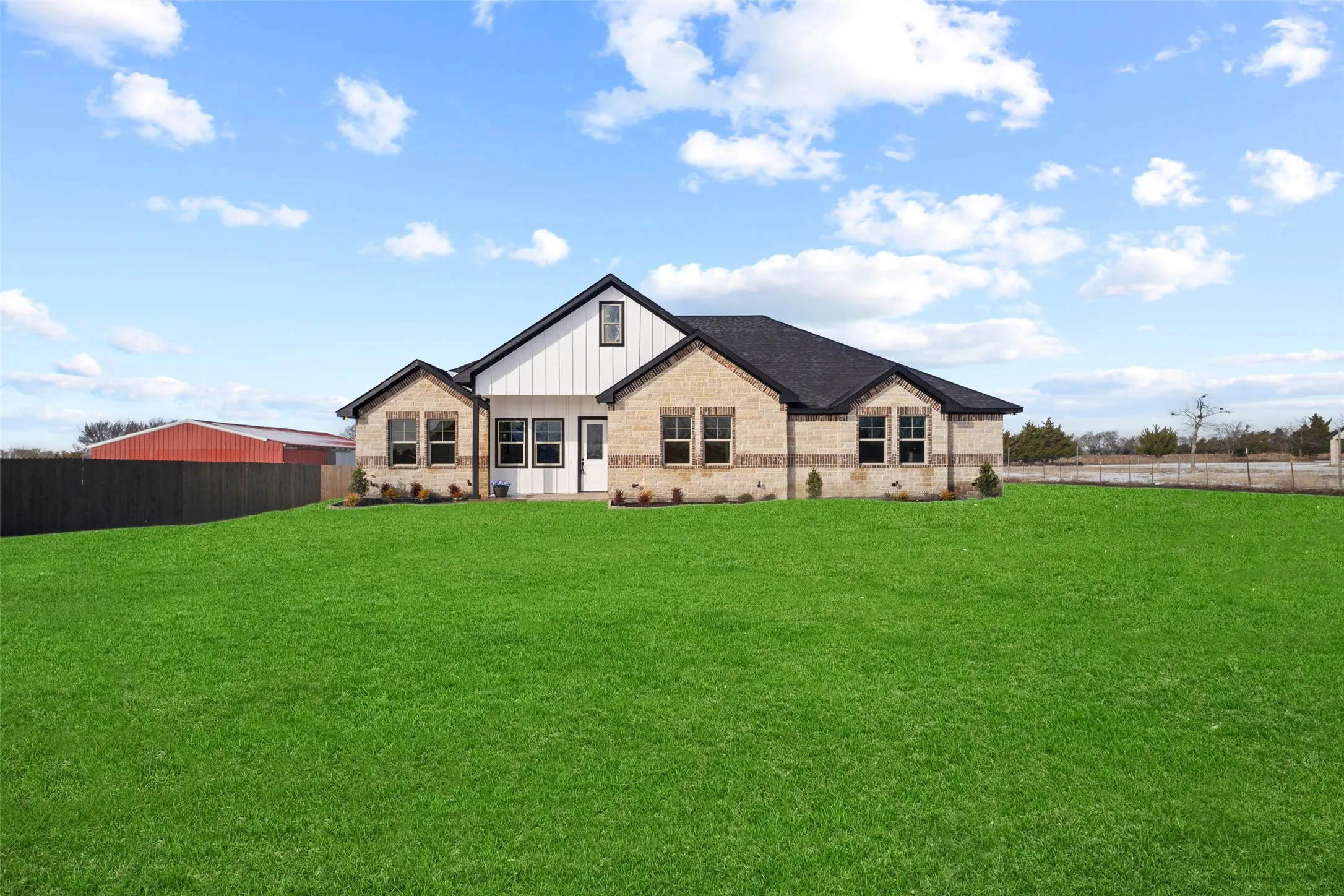 Spacious property featuring a large green lawn surrounding a single-story residence