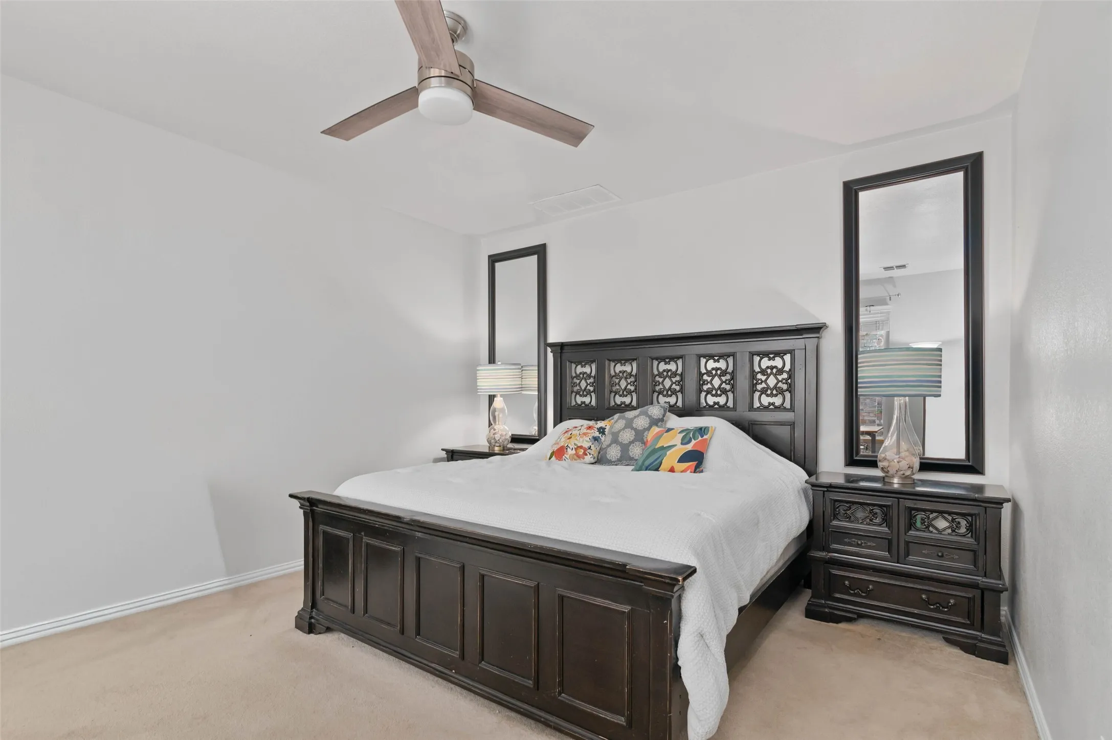 Carpeted bedroom featuring a ceiling fan with integrated lighting