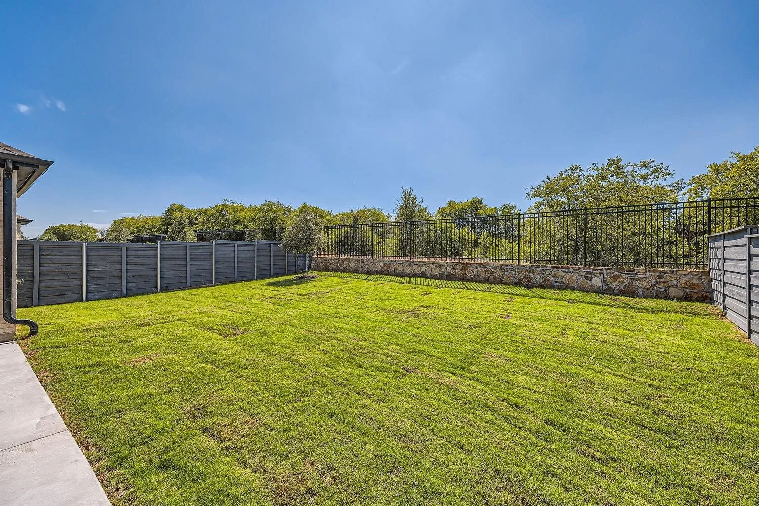 Expansive backyard featuring a lush lawn