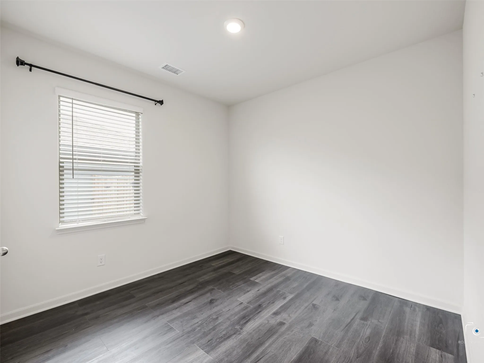 Wood-finish flooring, recessed lighting, and a window with blinds