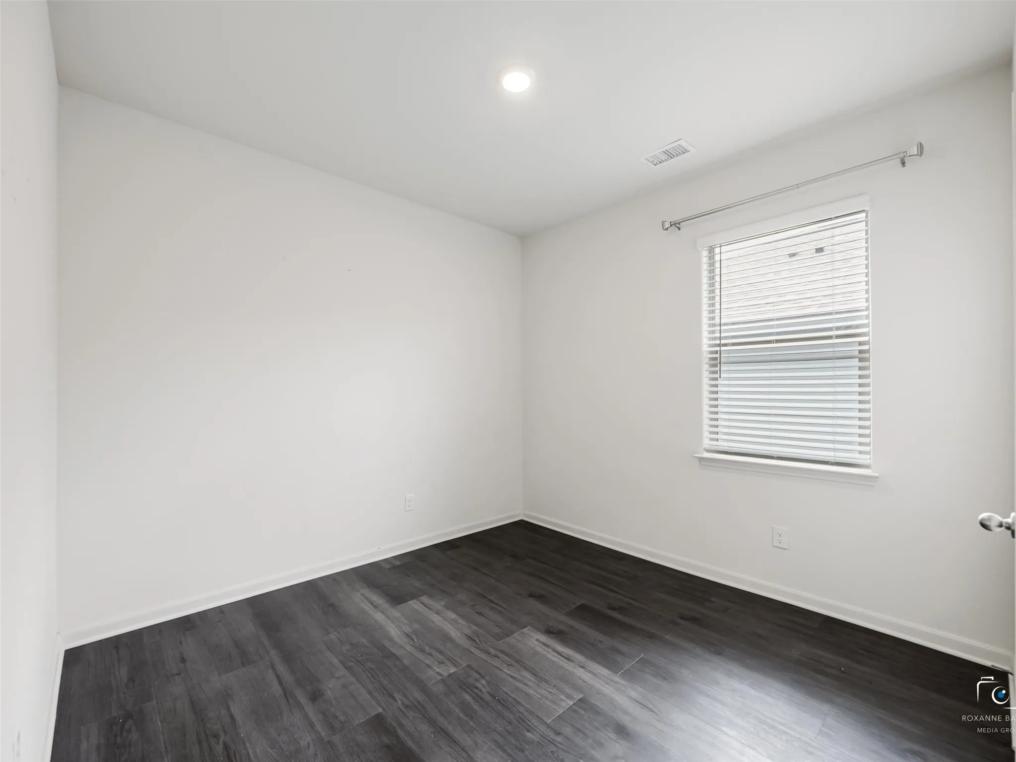 Recessed lighting, wood-finish flooring, white walls, and a window with blinds