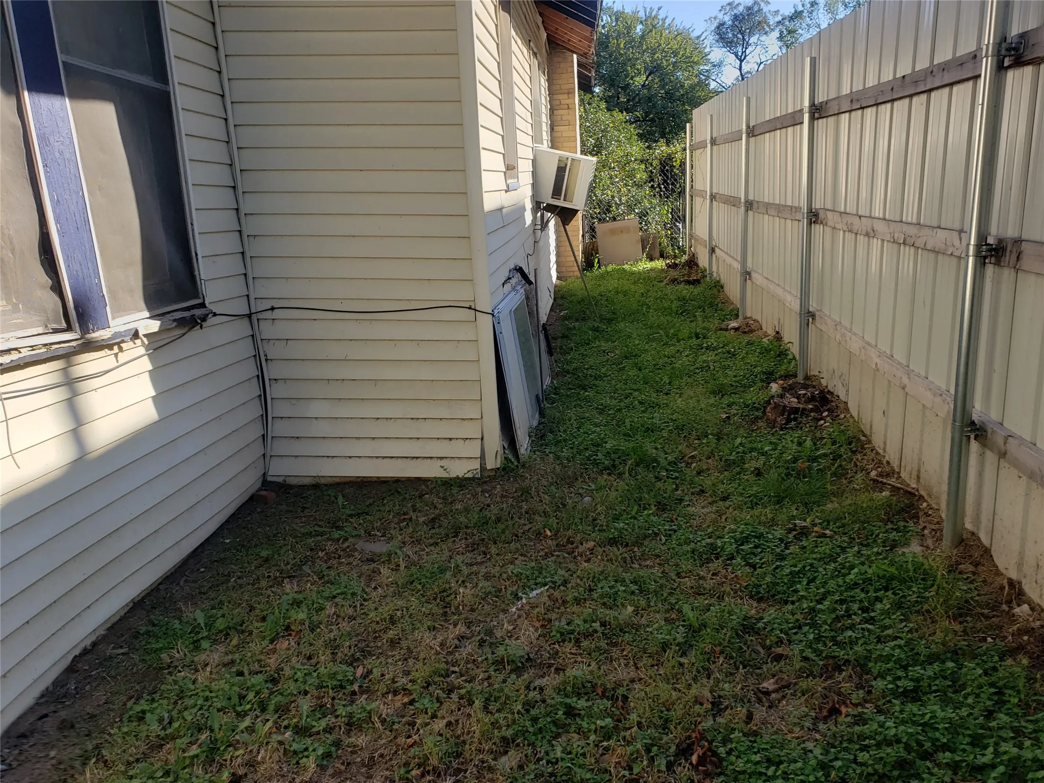 View of side of property with cooling unit