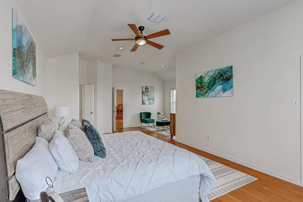 Vaulted ceilings with recessed lighting, wood-finish flooring, and a ceiling fan