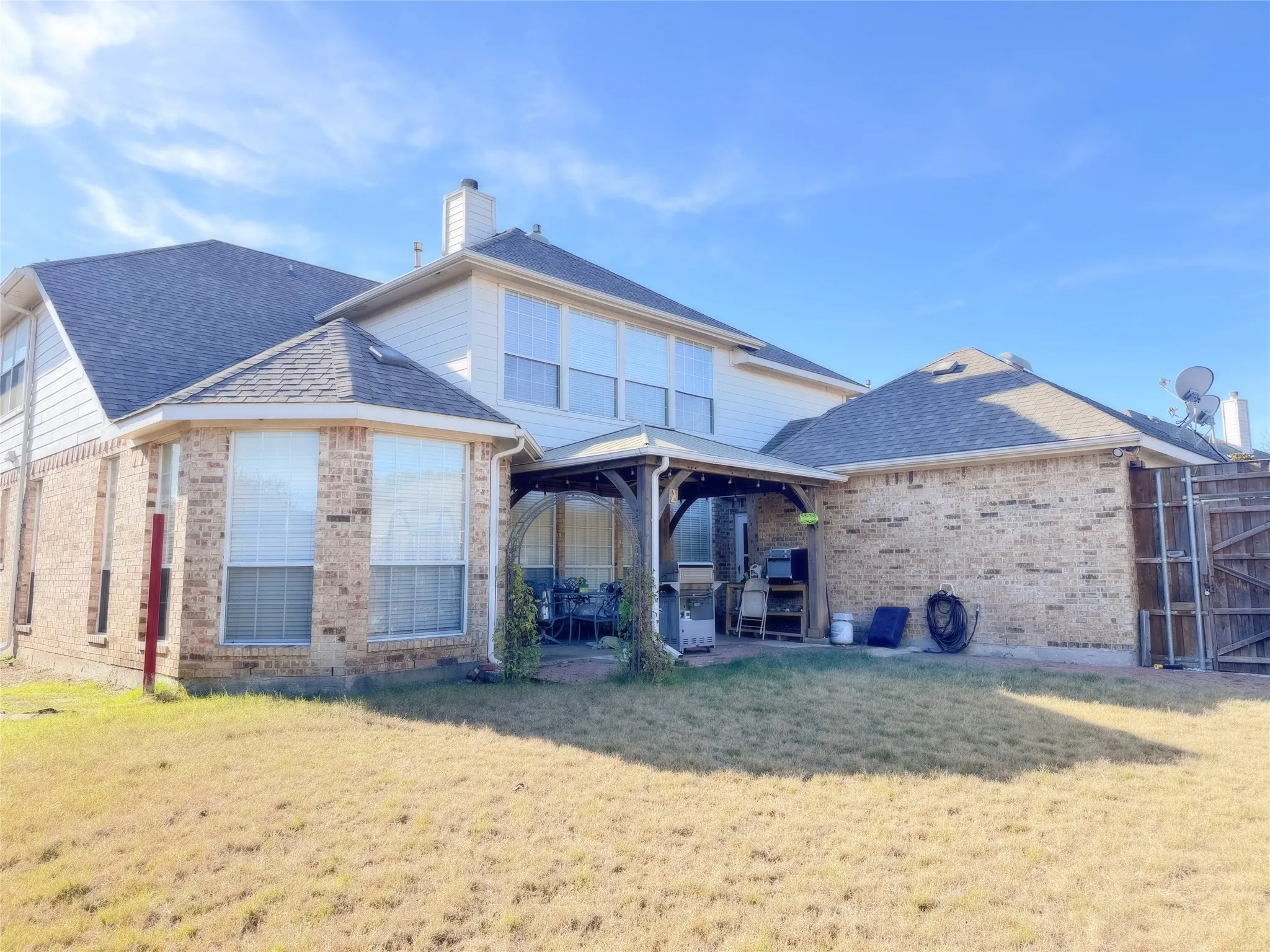 Exterior showcasing brick and siding construction with multiple window configurations