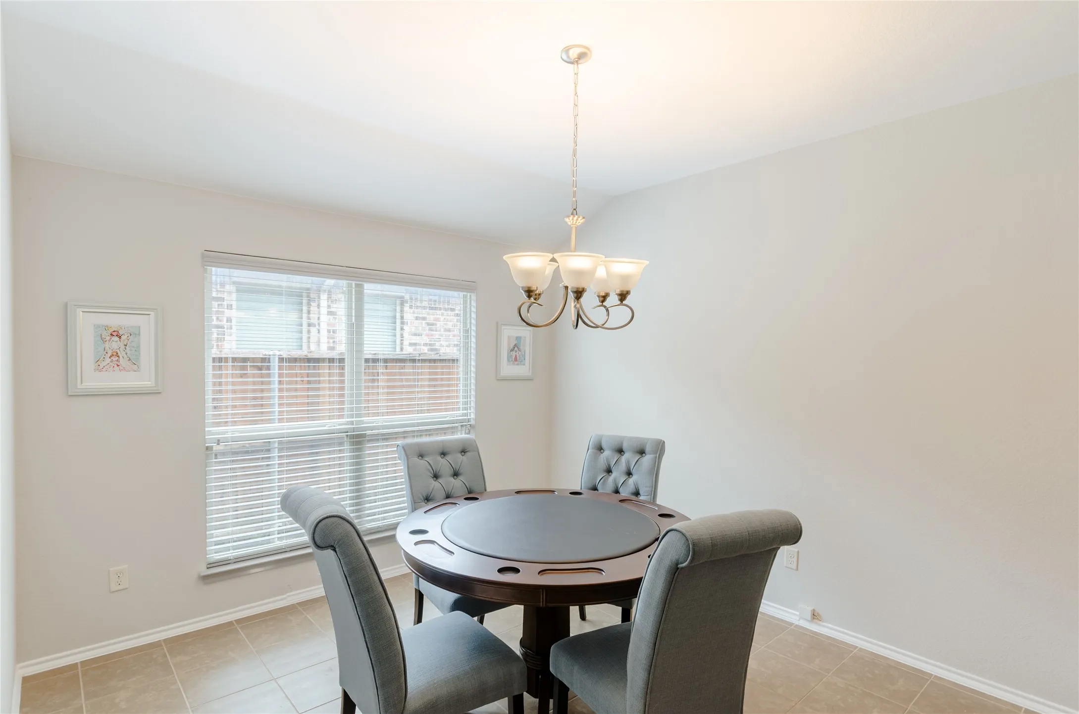 Neutral-toned interior room featuring tile flooring and a multi-paned window with blinds