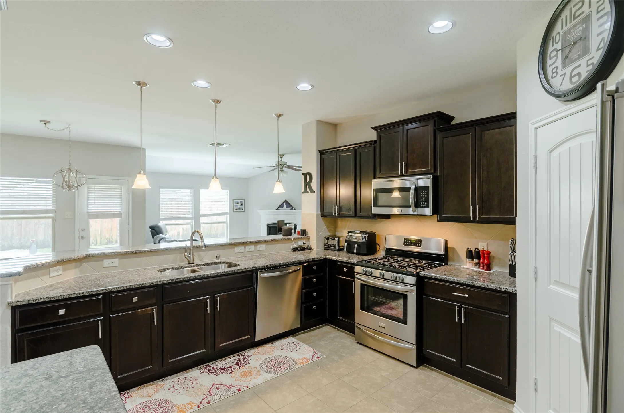 Kitchen featuring dark wood cabinetry and stainless steel appliances
