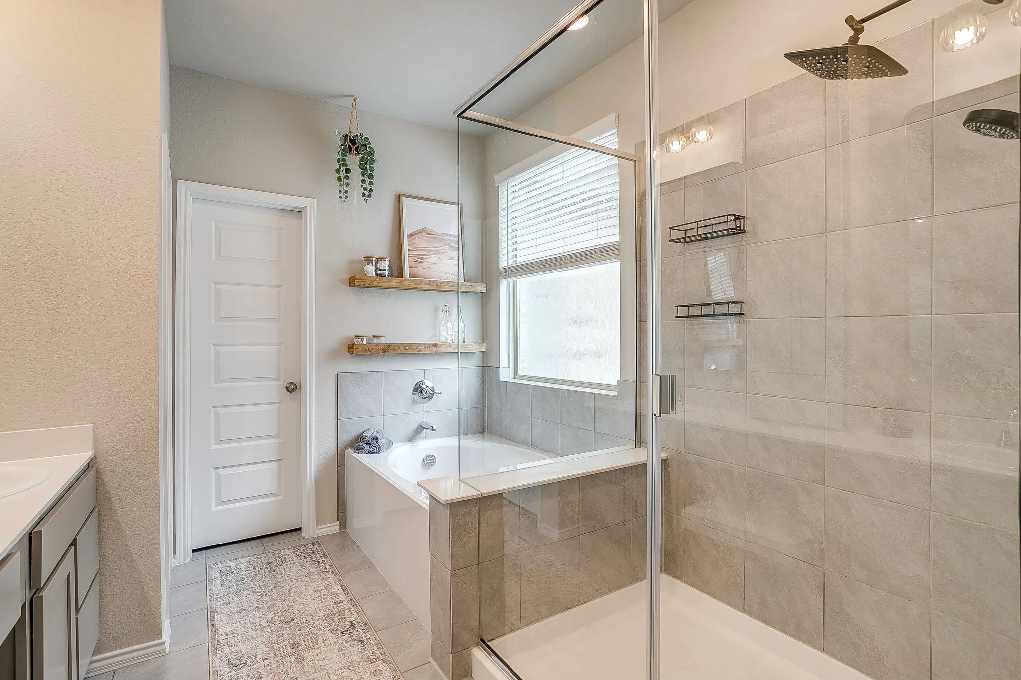 Spa like bathroom with neutral finishes, large walk in shower and separate tub.