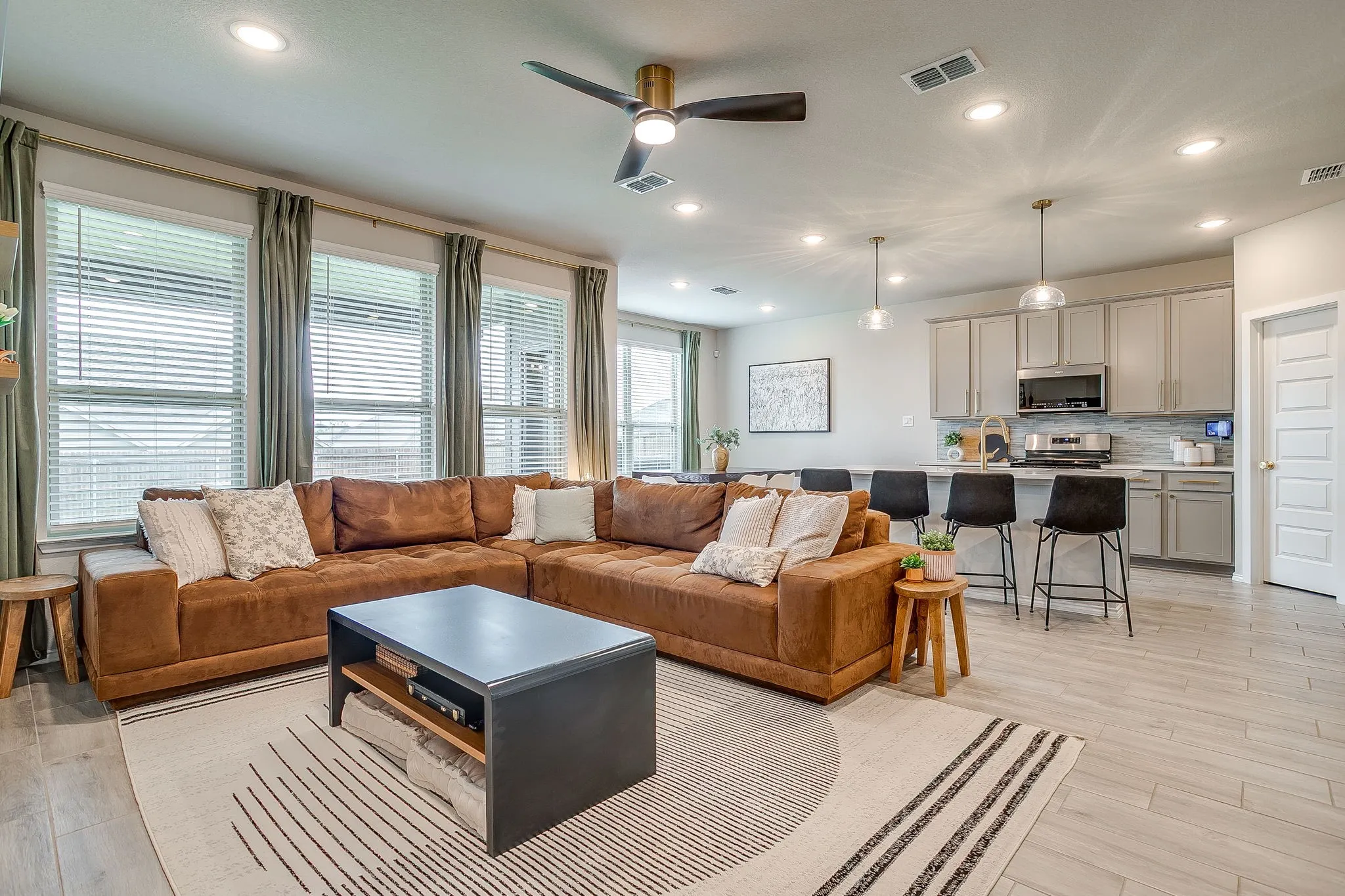 Bright windows, upgraded ceiling fan and wood look tile floors throughout the main floor.
