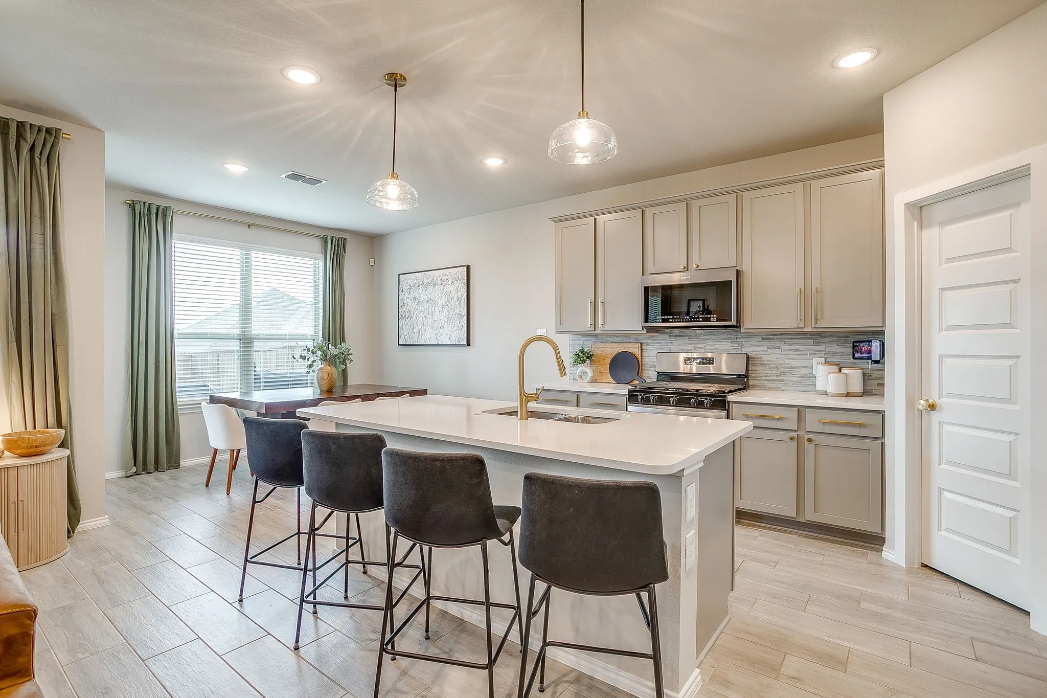 Upgraded pendant lights over counter height breakfast bar.