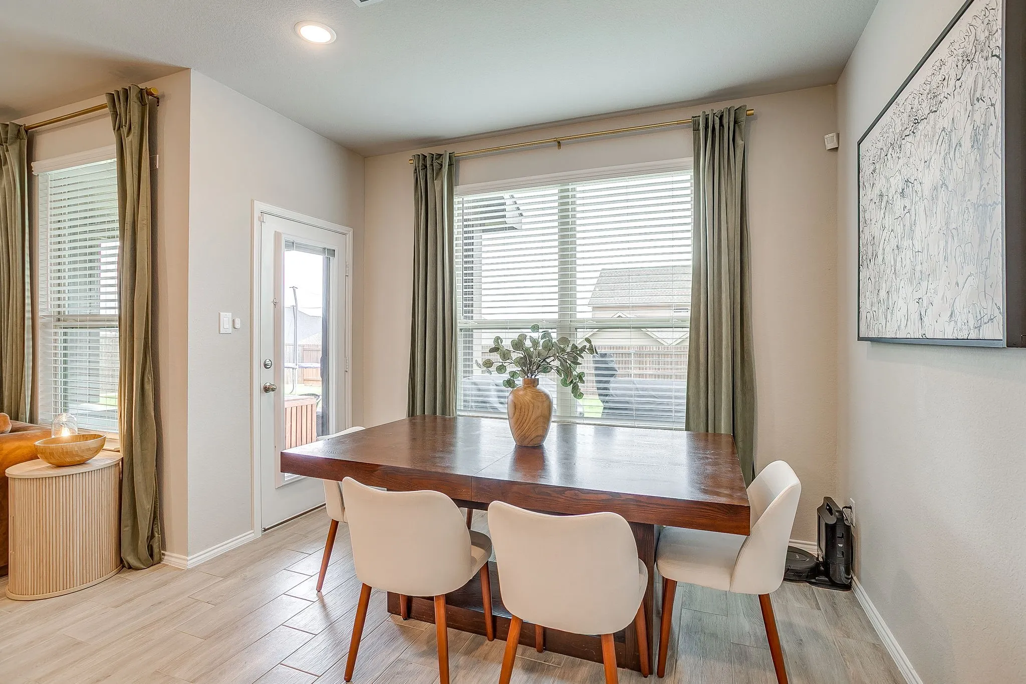 Dining nook features perfect lighting and windows.  Plenty of space for your favorite dining table.  Access to back patio.