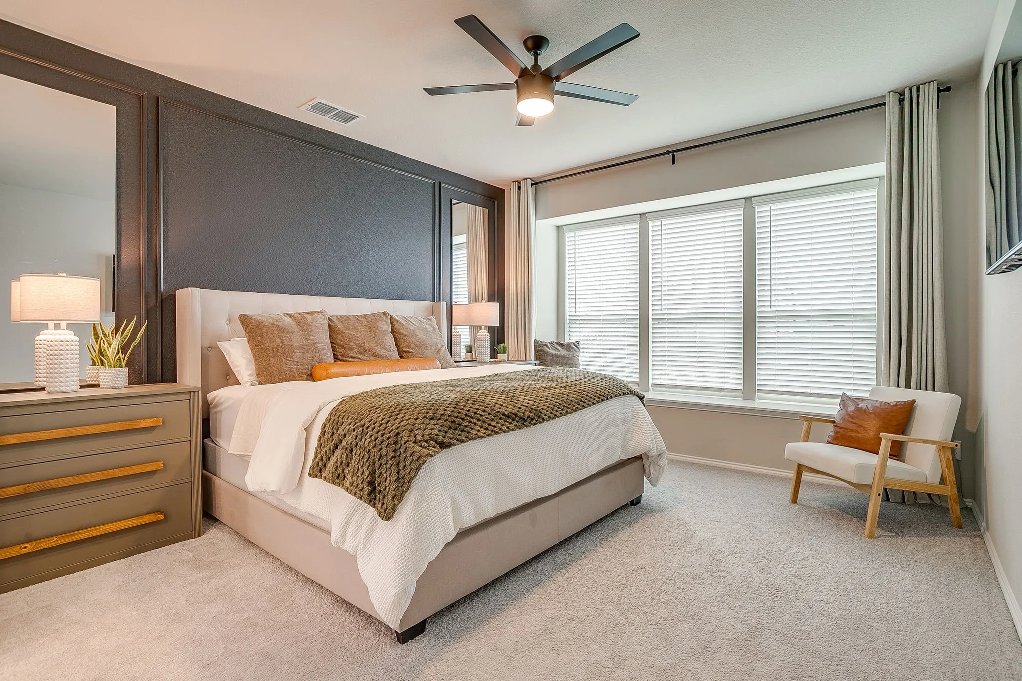 Primary ensuite is luxurious featuring accent wall, designer ceiling fan and bay window.