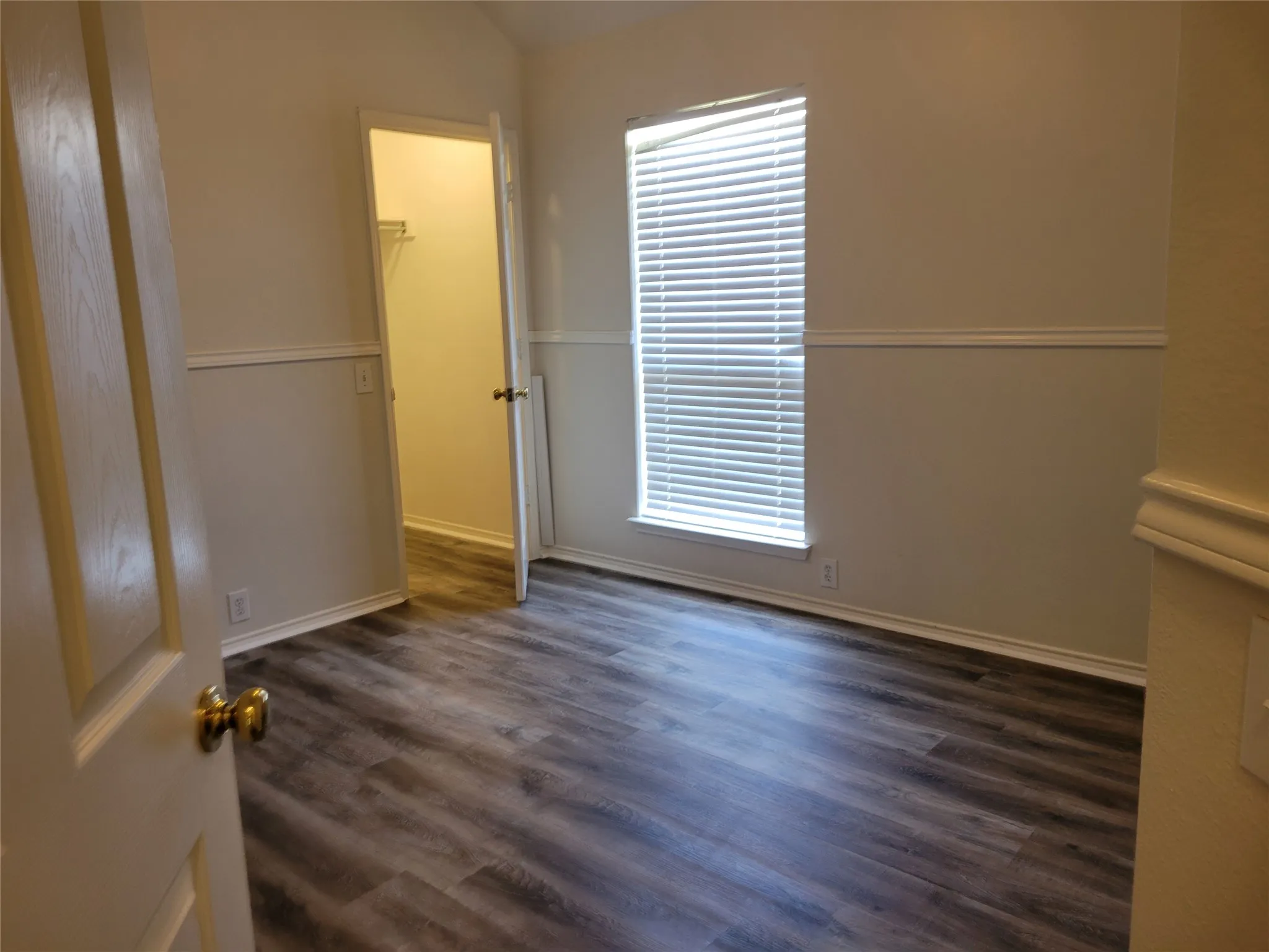 3rd bedroom with large walk-in closet and new laminate flooring