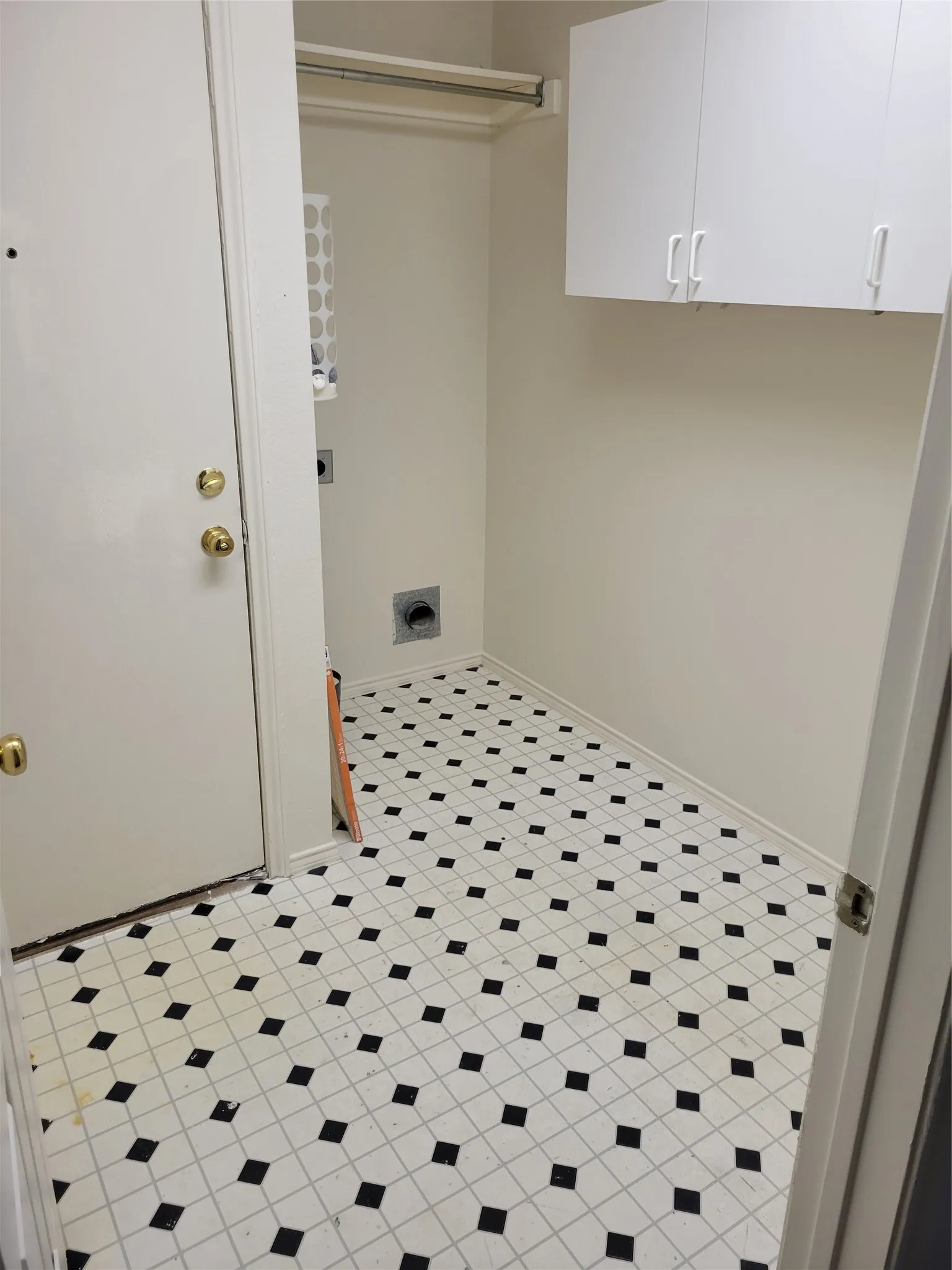 Washroom with cabinets, light tile patterned flooring, and electric dryer hookup