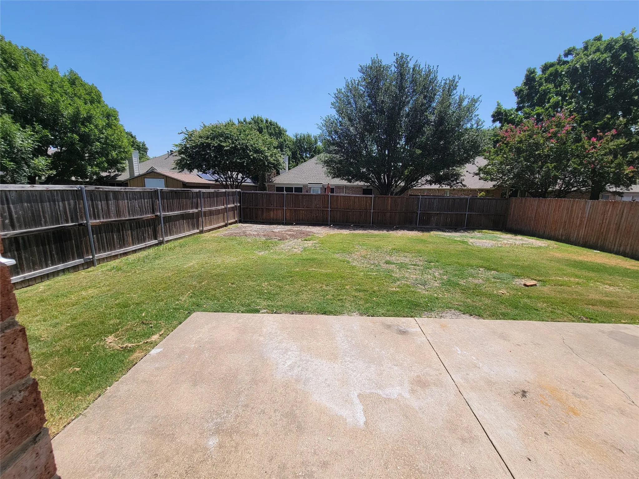 View of yard with a patio and some new fence