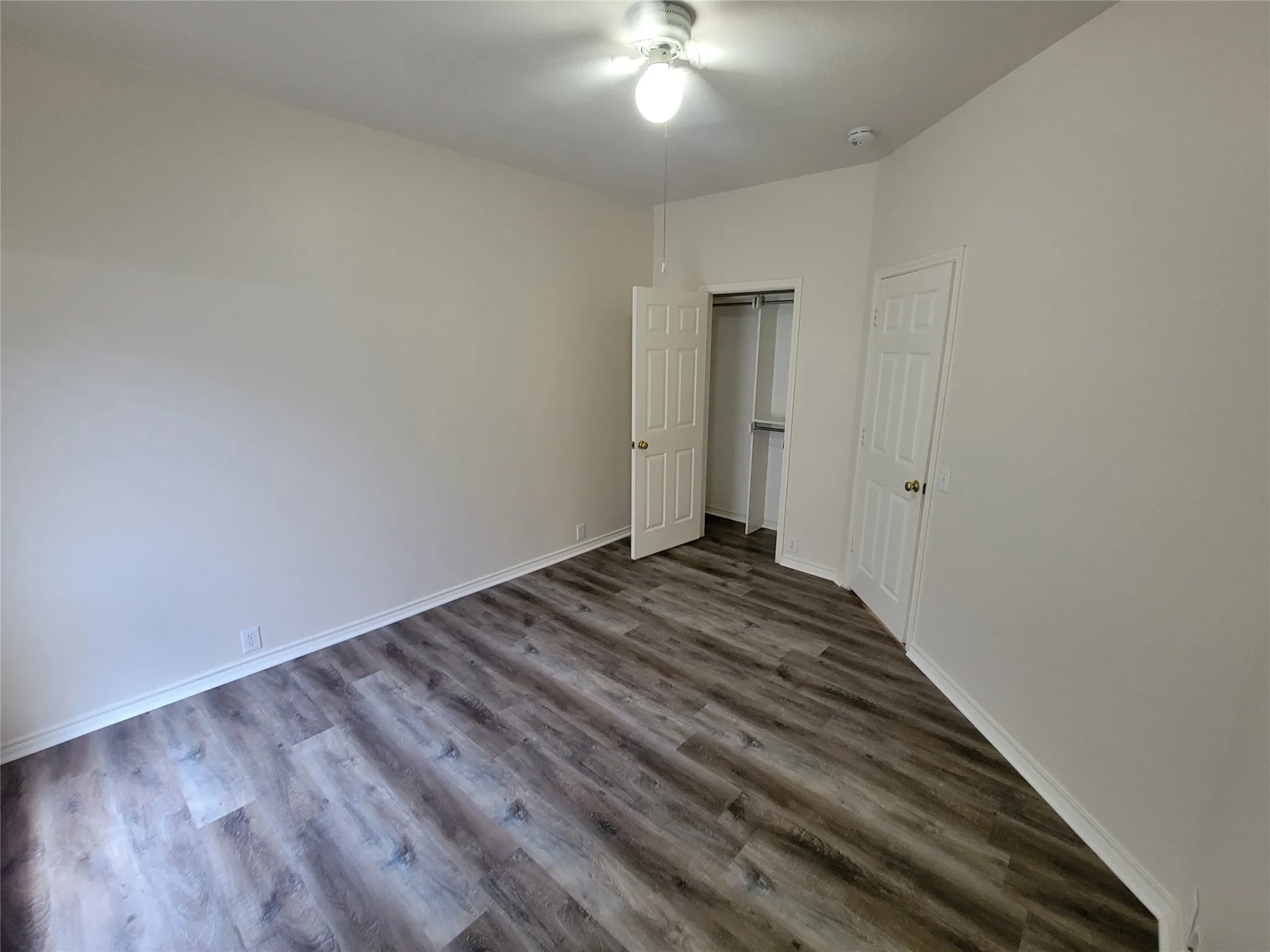 2nd bedroom with walk-in closet and new laminate flooring