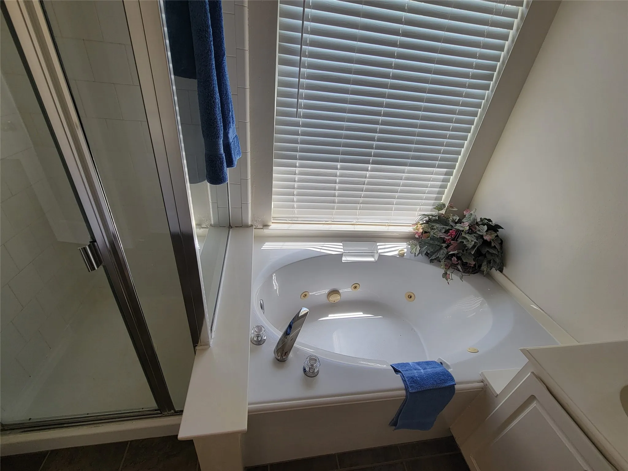 Bathroom featuring tile patterned flooring, separate shower and tub, and double vanity