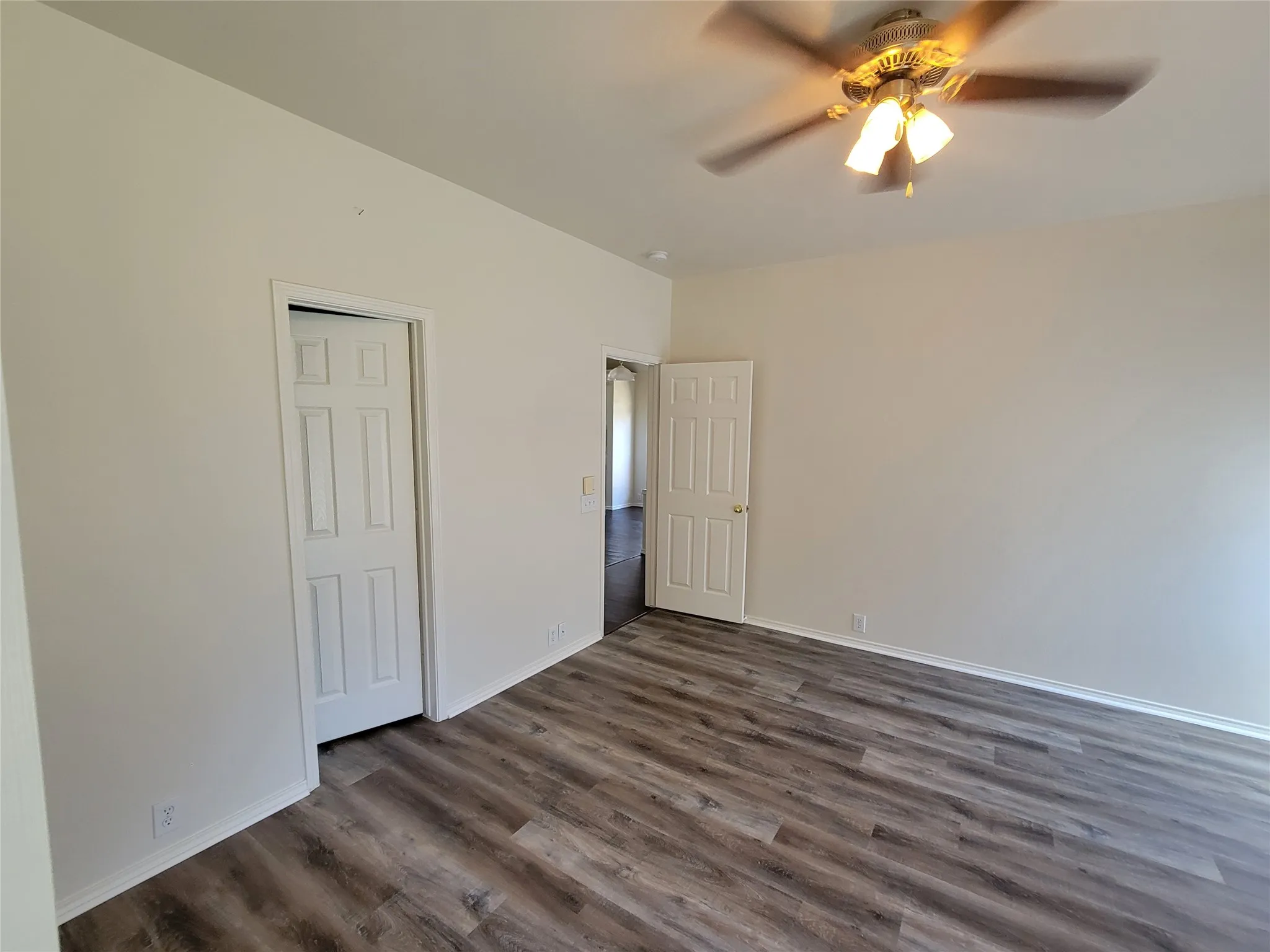 Master with new laminate flooring, large walk-in closet and ceiling fan