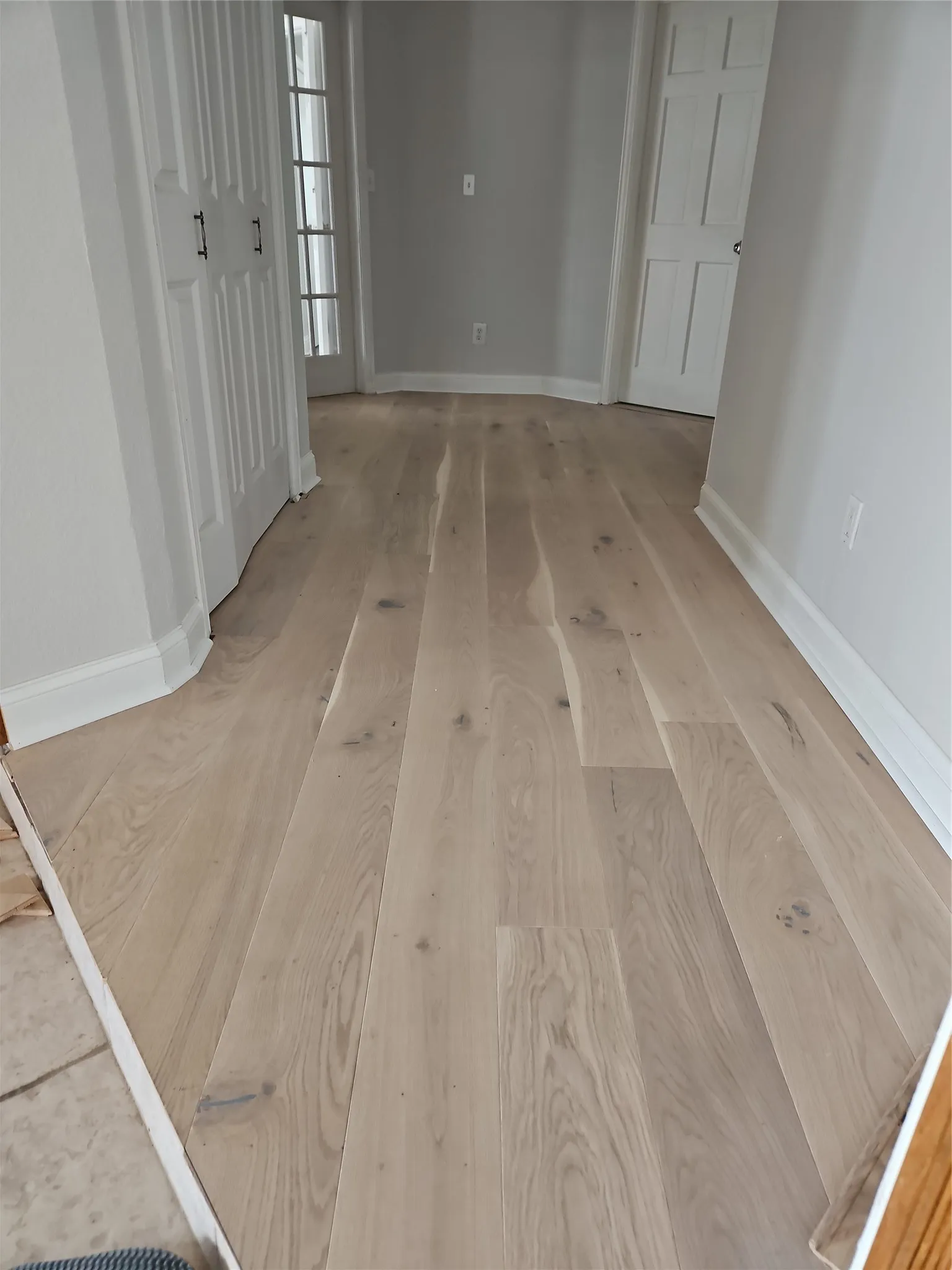 Hallway To Bedrooms Showing White Hardwood