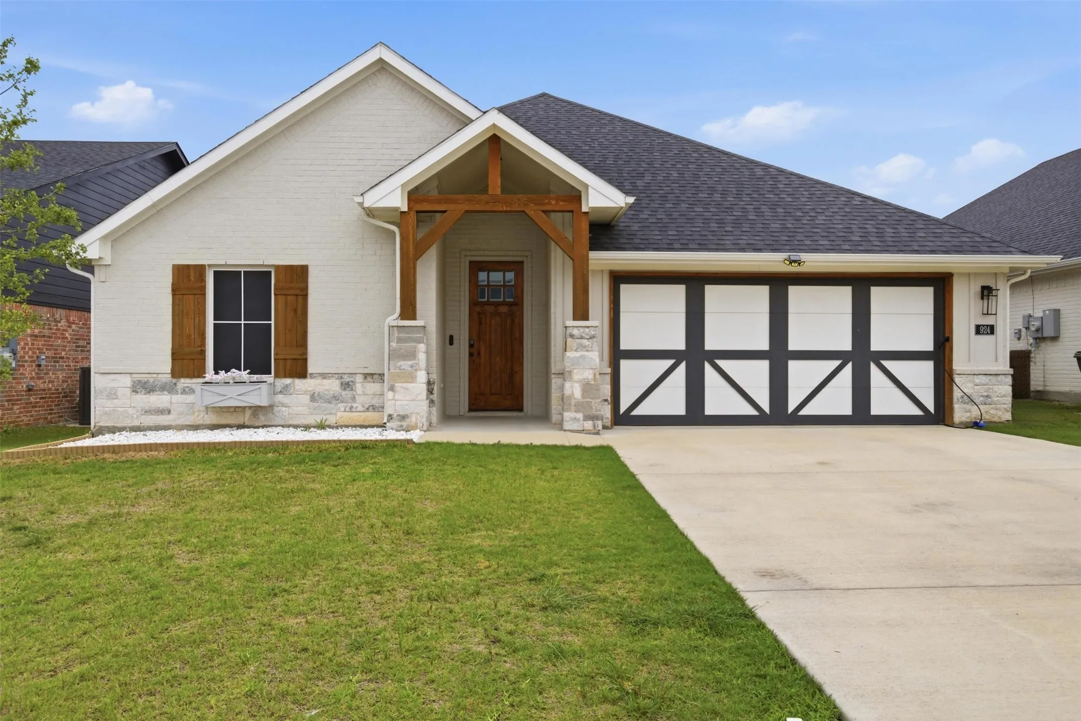 Front view of home welcomes you with covered entry way, front facing 2 car garage